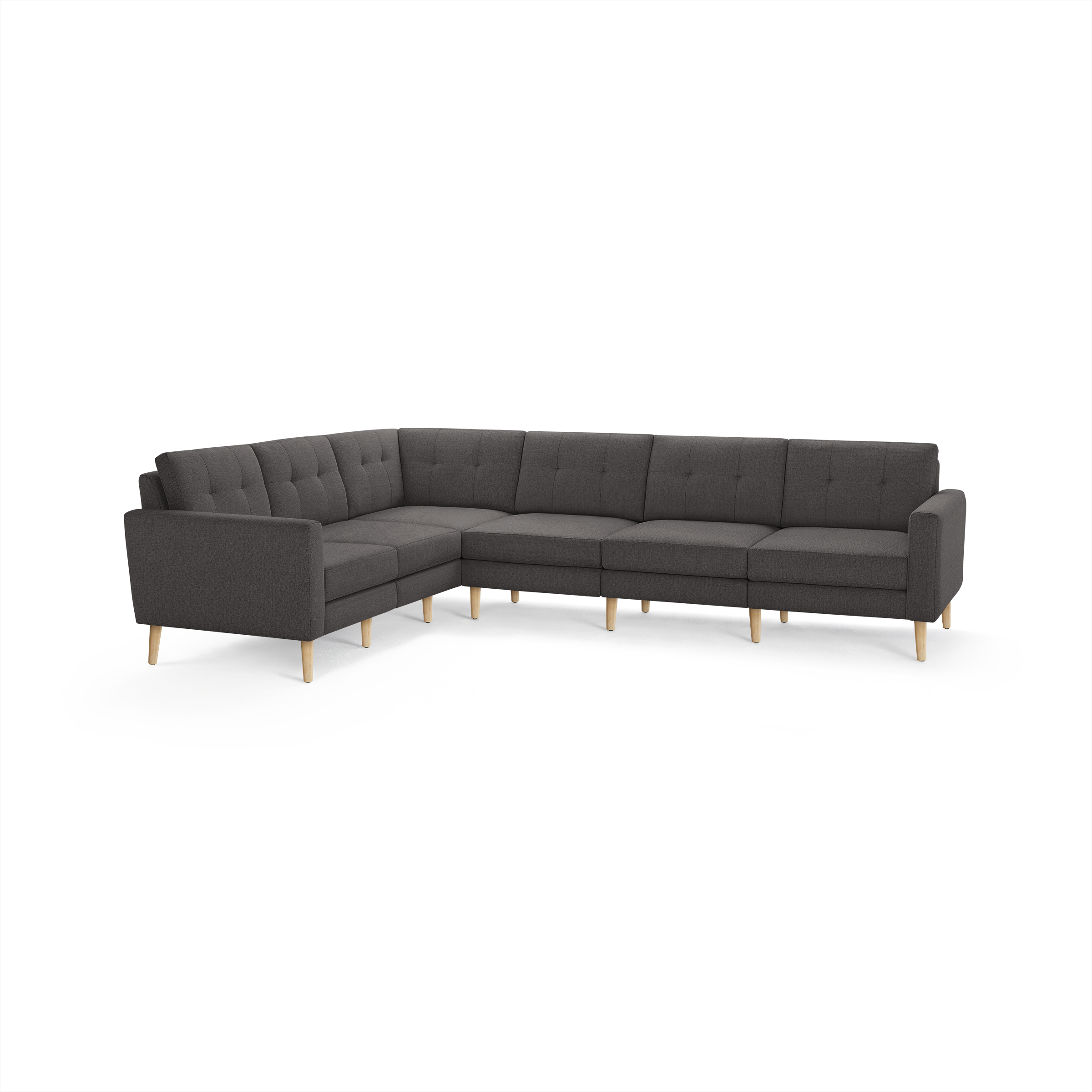 Dark gray fabric upholstered L-shaped sectional sofa with tufted back cushions and light wooden legs.