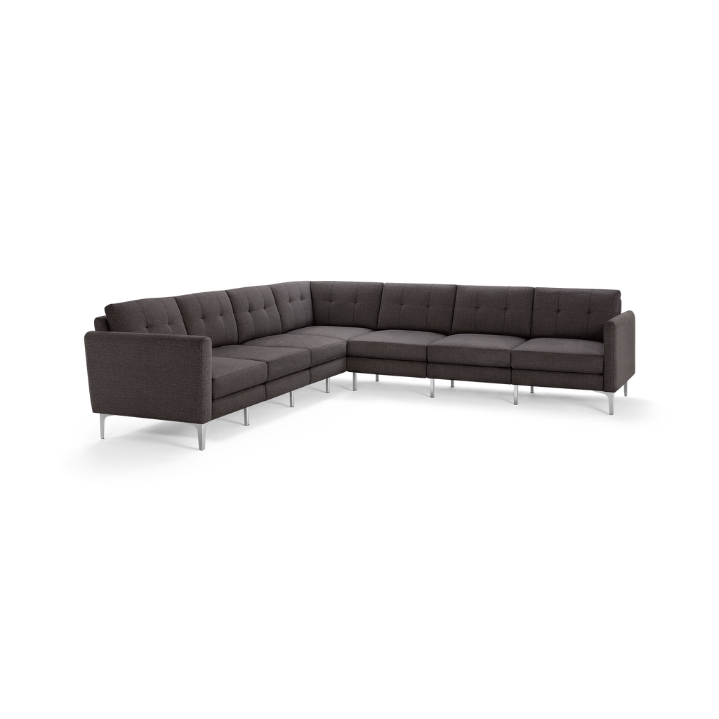 Modern dark gray upholstered L-shaped sectional sofa with tufted back cushions and slim metal legs.