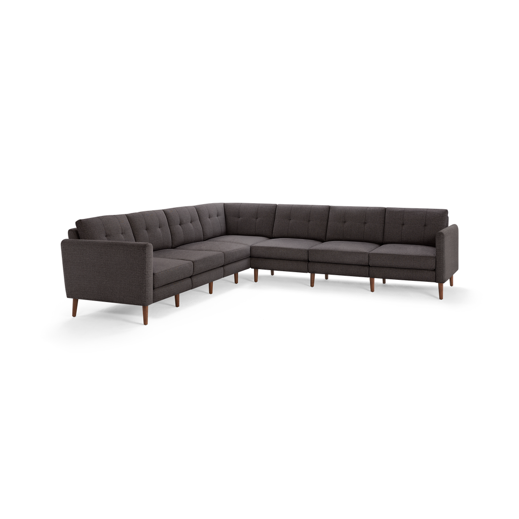Dark gray L-shaped sectional sofa with tufted cushions and wooden legs, featuring a modern minimalist design.