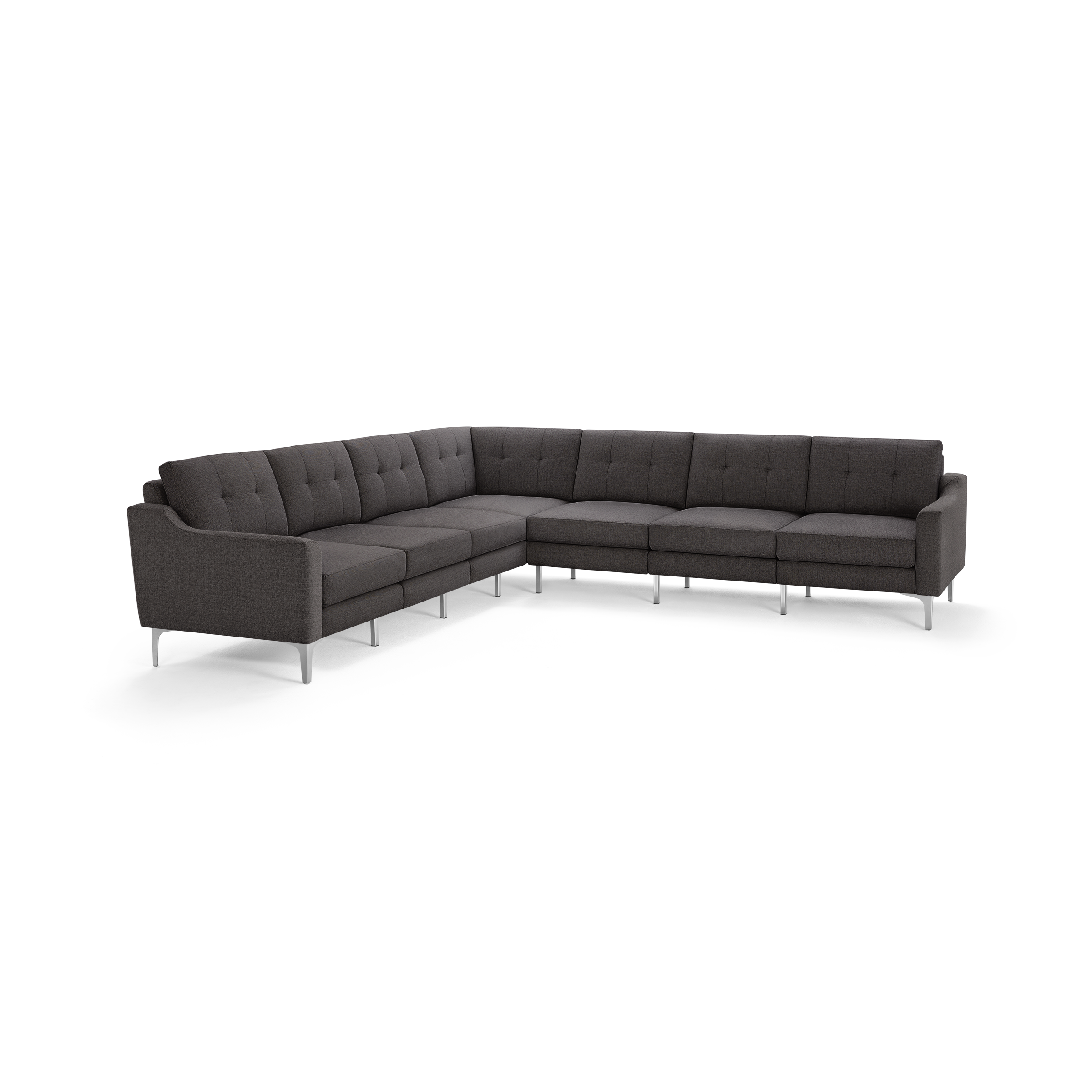 Large modern L-shaped sectional sofa in dark gray fabric with tufted back cushions and slender metal legs.