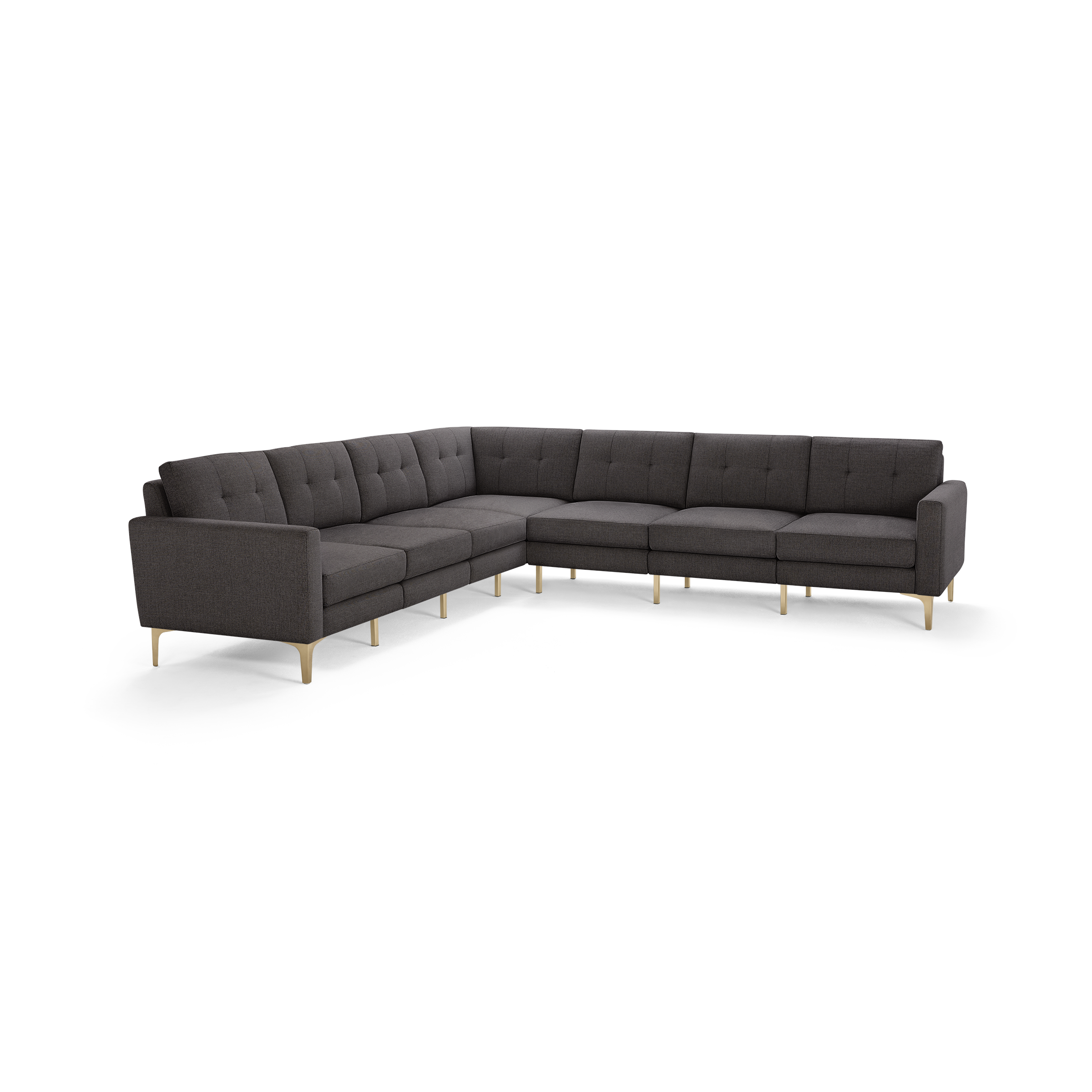 Large modern L-shaped sectional sofa in dark grey fabric with tufted back cushions and light wooden legs.