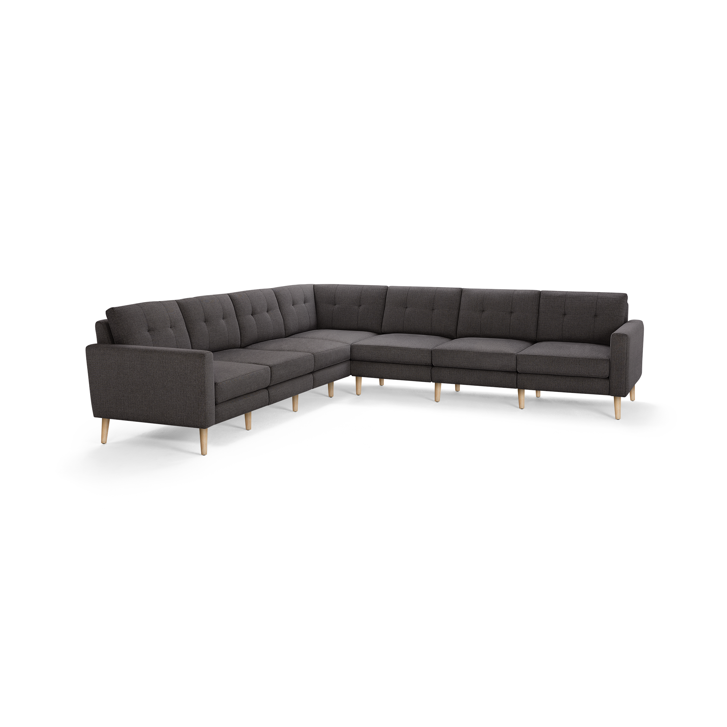 Large L-shaped sectional sofa with dark gray tufted upholstery and light wooden legs, modern and minimalist design.