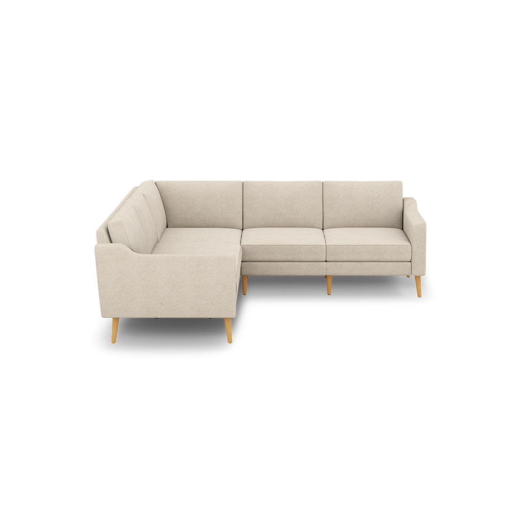Beige fabric L-shaped sectional sofa with wooden tapered legs and clean, modern design, showing left-facing chaise side.