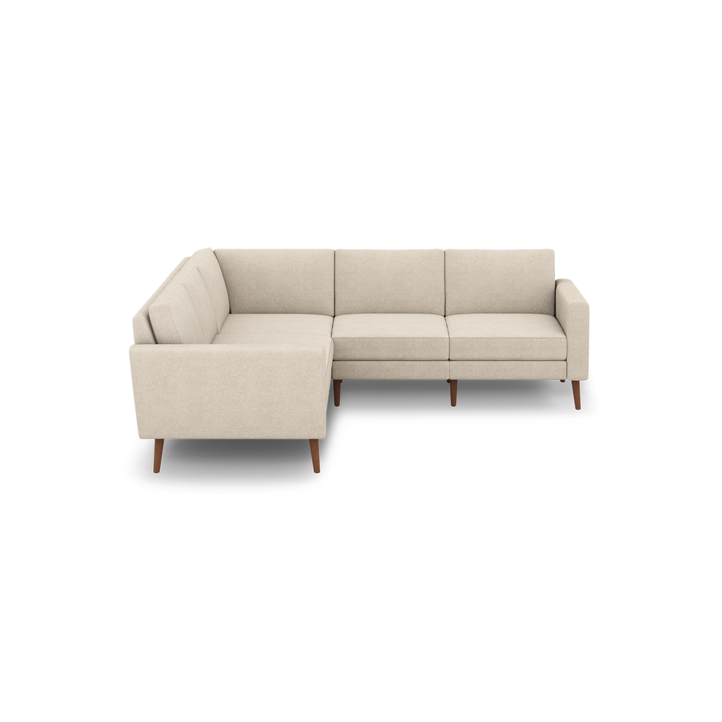 Beige fabric L-shaped sectional sofa with wooden legs and clean, modern design.