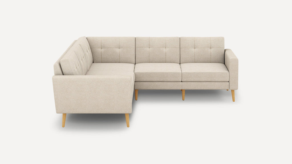 Beige fabric L-shaped sectional sofa with tufted back cushions and light wooden legs, perfect for modern living rooms.