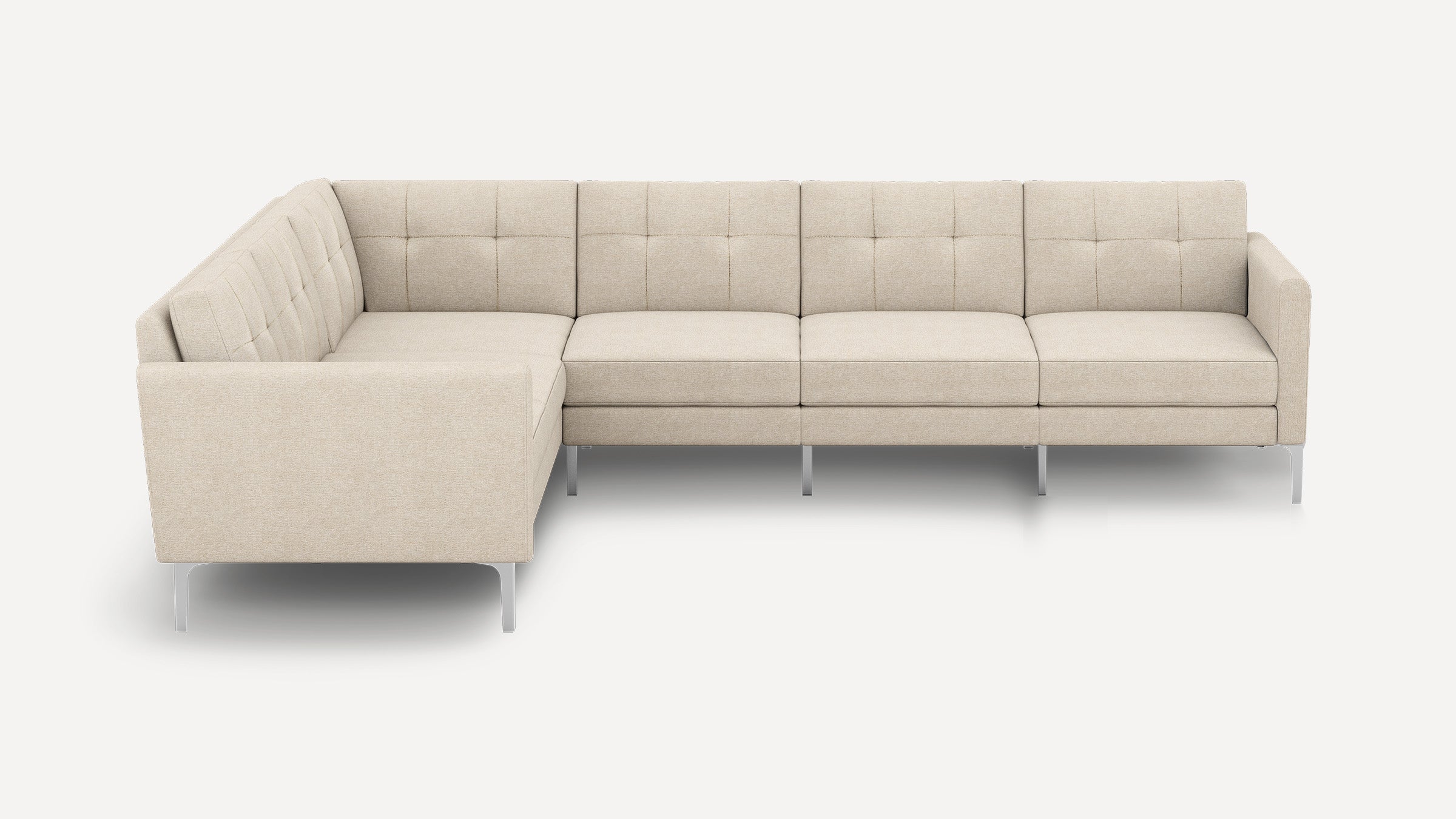Modern L-shaped sectional sofa with beige tufted fabric upholstery and slim metal legs, designed for spacious seating.