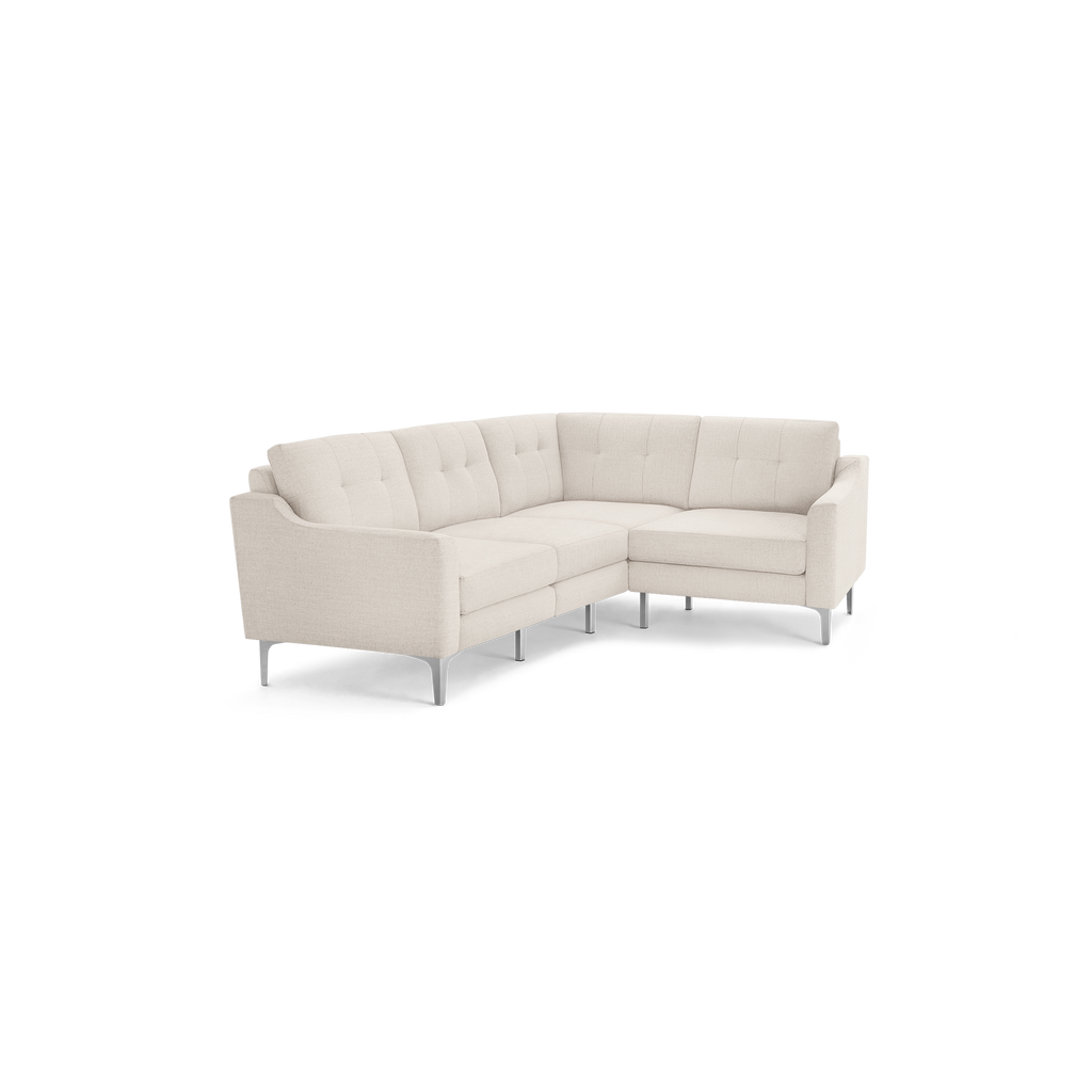 L-shaped beige fabric sectional sofa with tufted back cushions and slim metal legs, featuring modern design and clean lines.