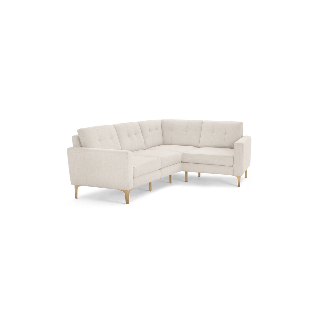 Light beige L-shaped sectional sofa with tufted back cushions and wooden tapered legs, modern and minimalist design.