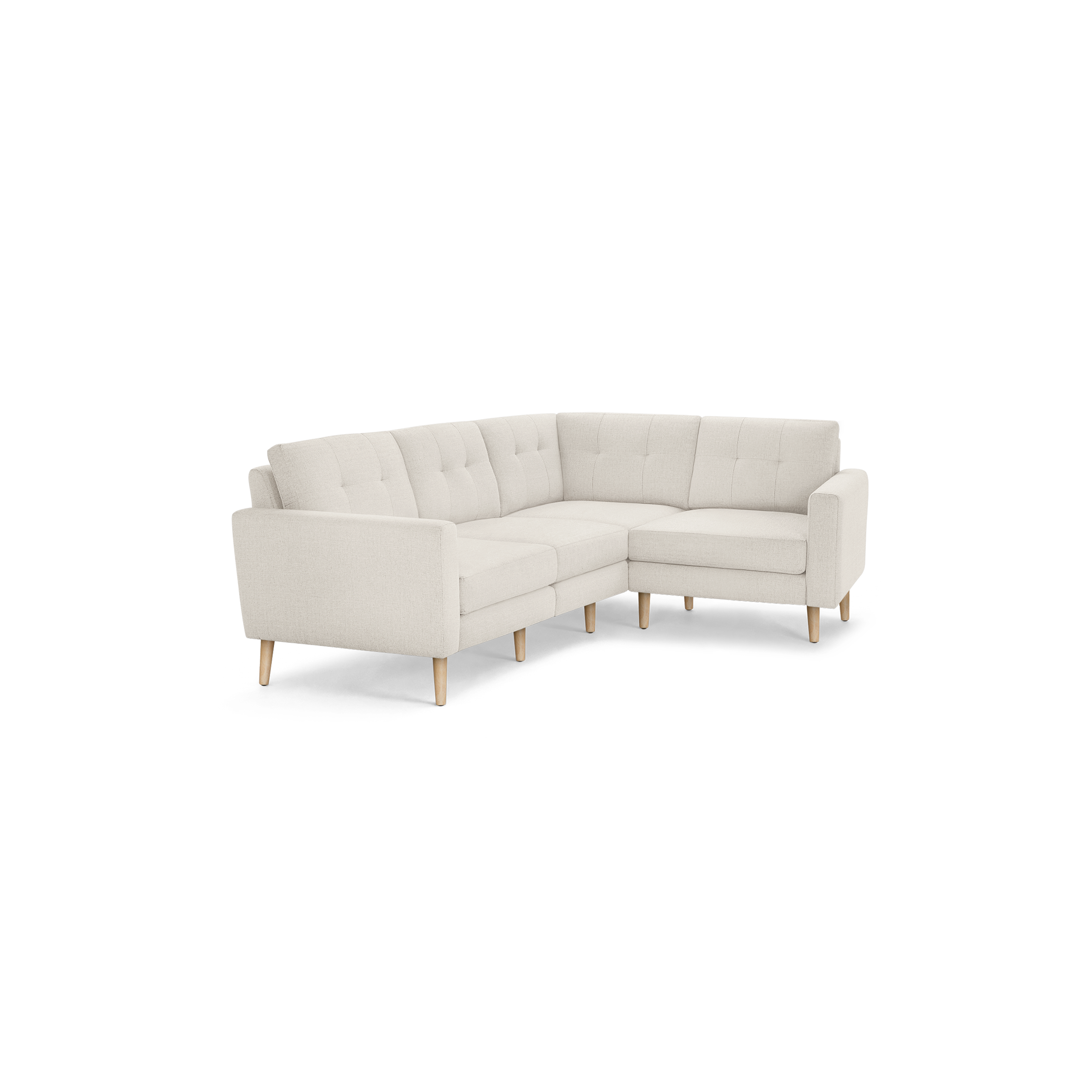 Light beige L-shaped sectional sofa with tufted back cushions and wooden legs.