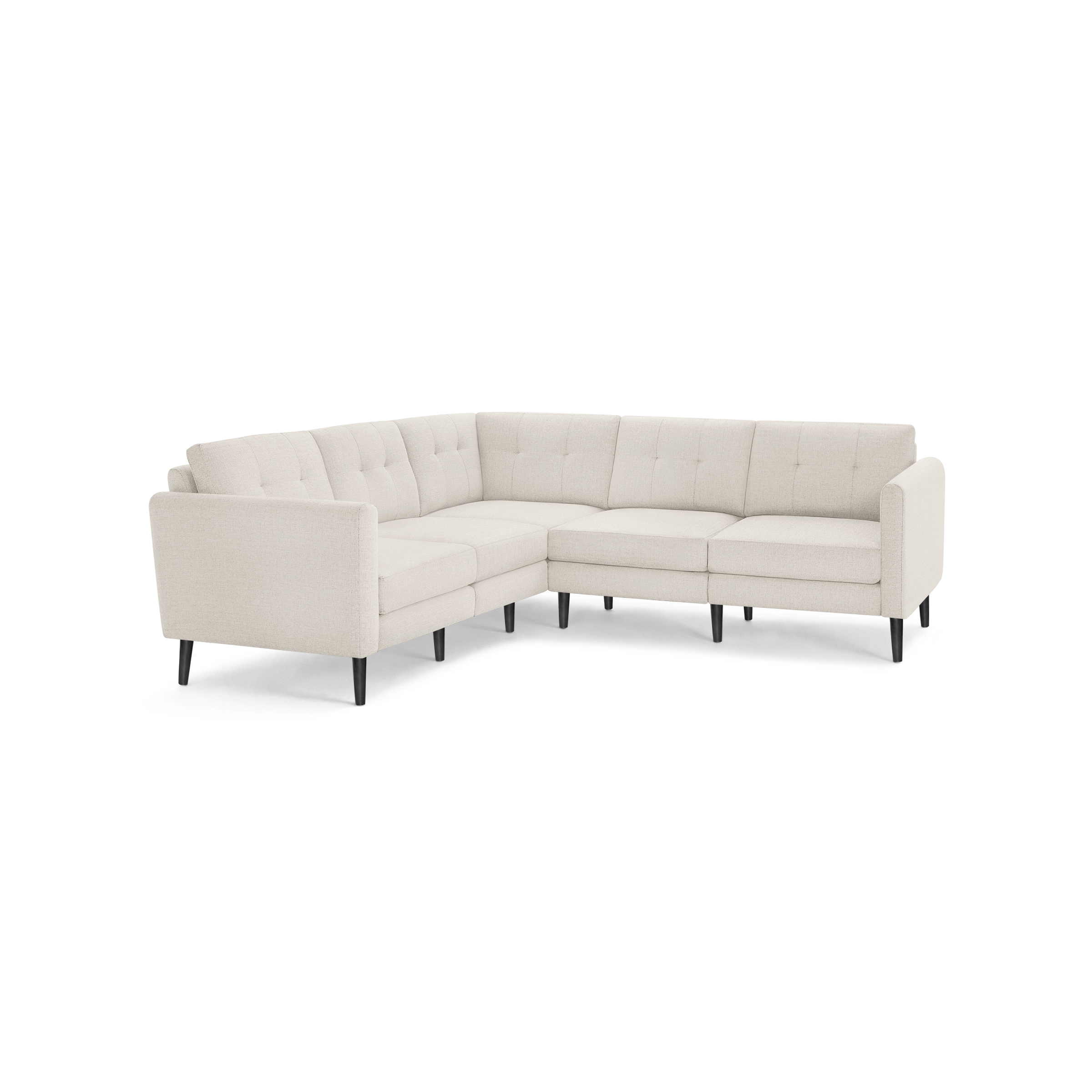 Beige fabric L-shaped sectional sofa with tufted back cushions and black tapered wooden legs on a black background.