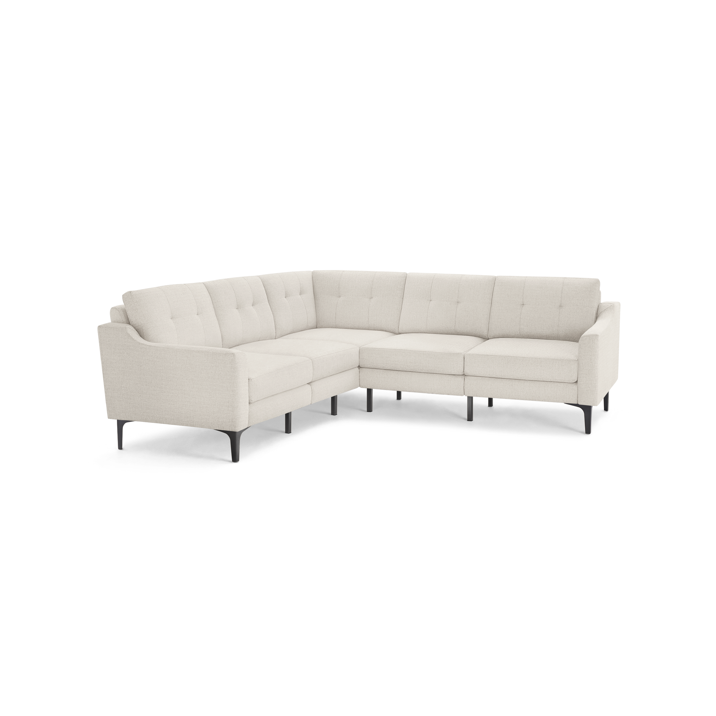 Modern L-shaped beige sectional sofa with tufted cushions, slim armrests, and black tapered legs on a black background.
