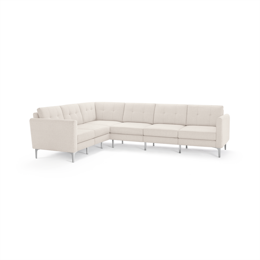 Cream-colored modern sectional sofa with tufted cushions and slim metal legs in an L-shaped layout.