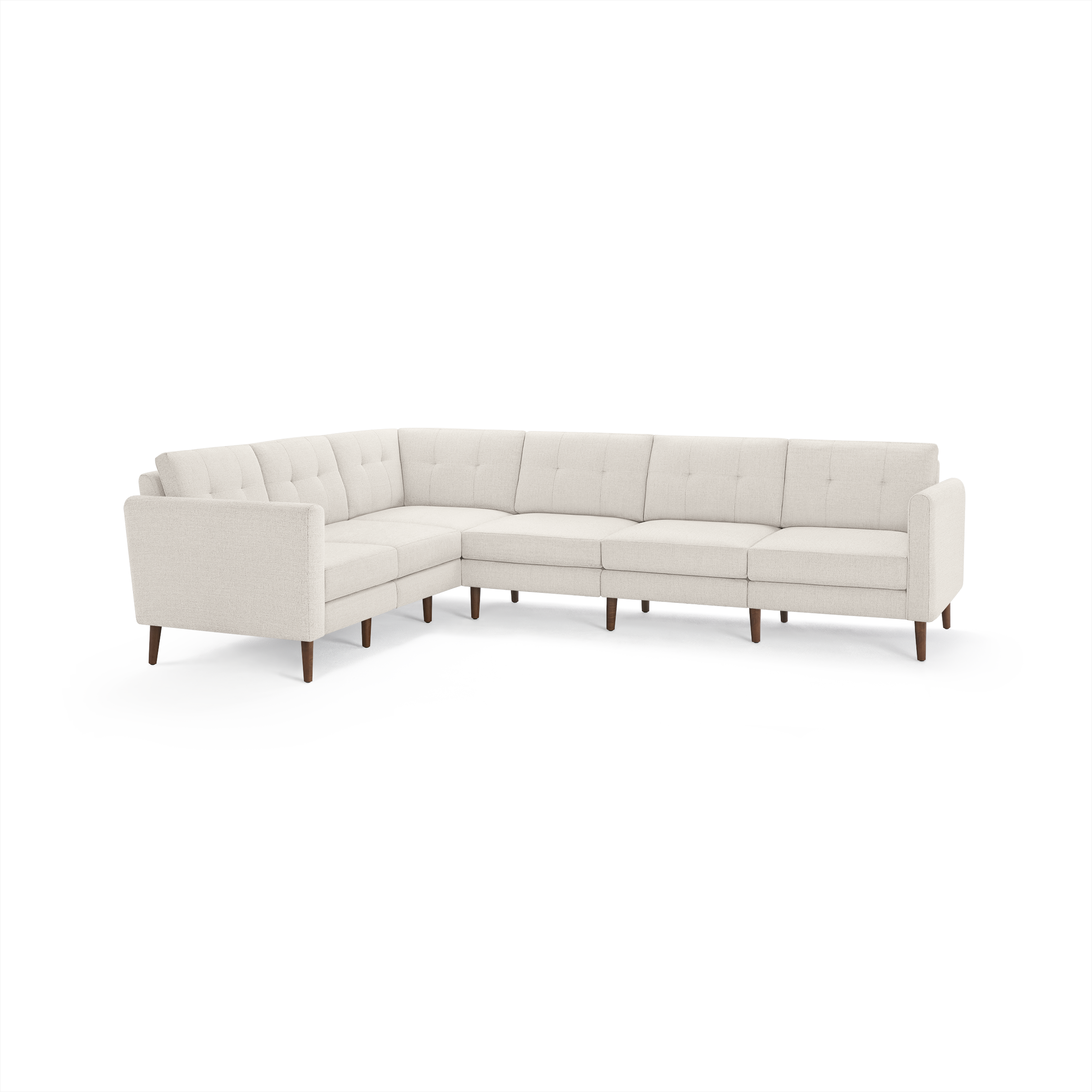 Large L-shaped sectional sofa in light beige fabric with tufted back cushions and wooden legs, designed for spacious living rooms.