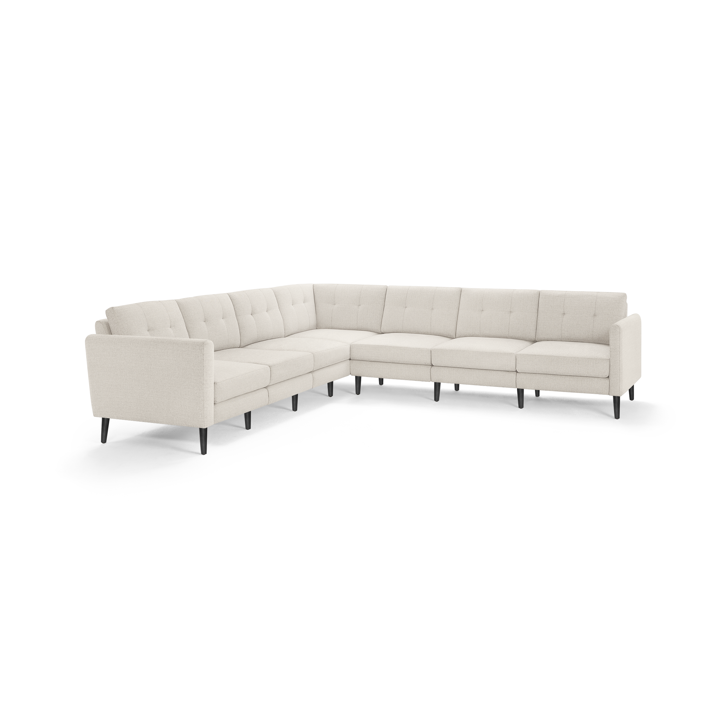 Large L-shaped beige fabric sectional sofa with tufted back cushions and black tapered wooden legs.