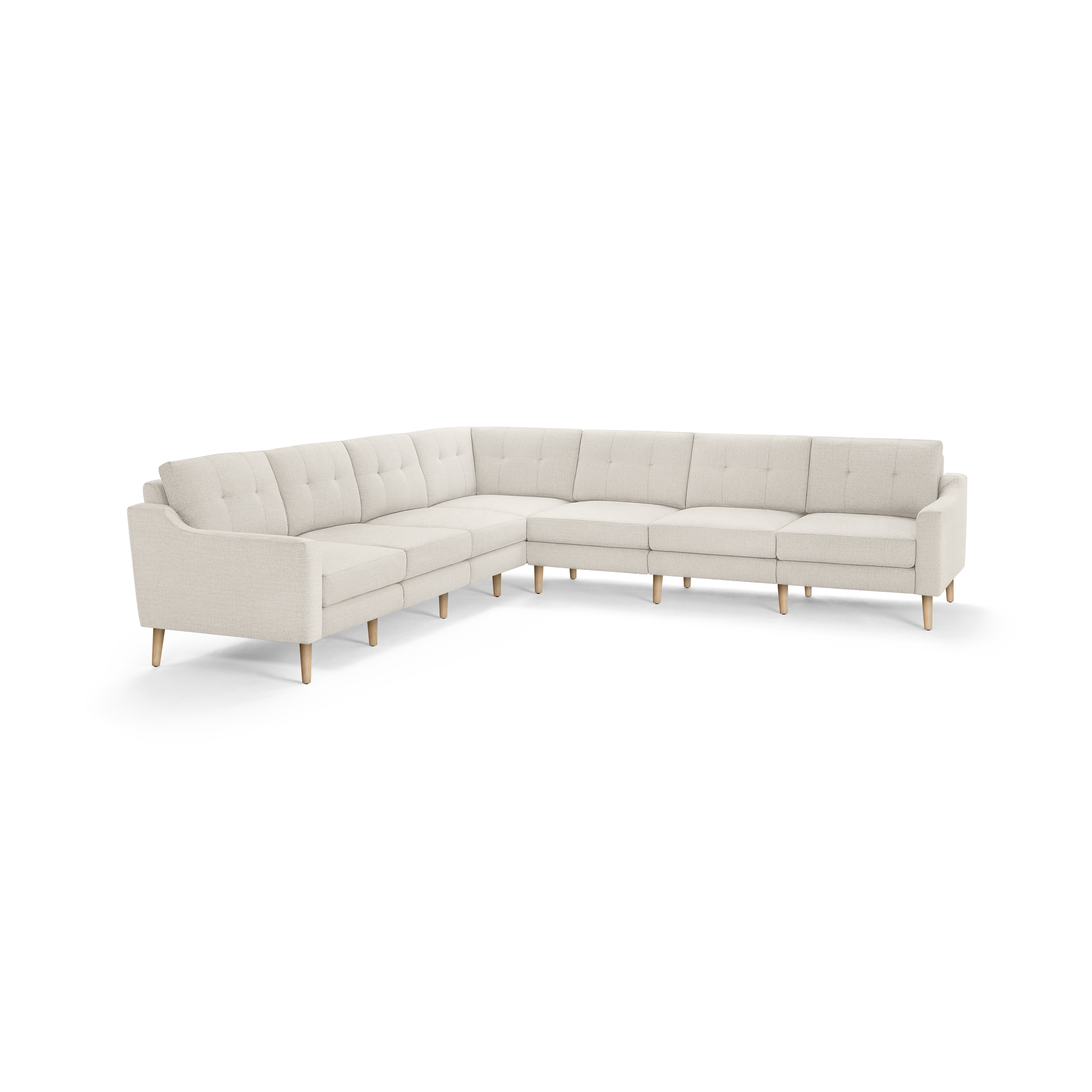 Large L-shaped beige sectional sofa with tufted back cushions and light wooden legs, designed for spacious living rooms.
