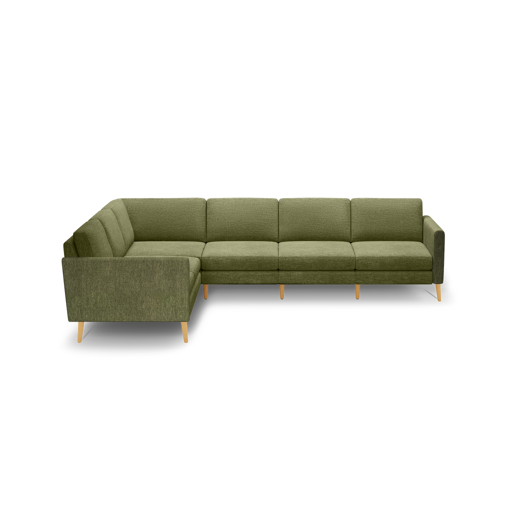 L-shaped sectional sofa with olive green fabric upholstery and light wooden legs against a black background.
