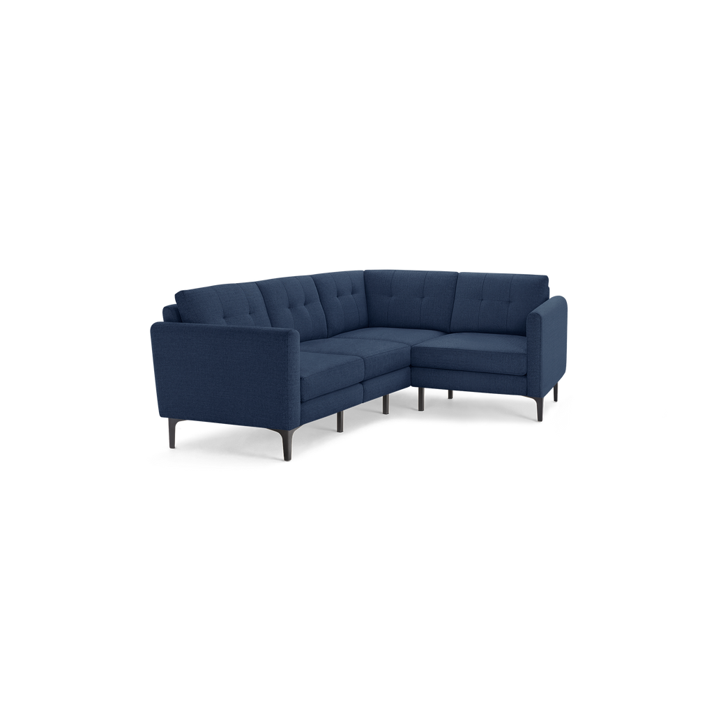 Navy blue modern L-shaped sectional sofa with tufted back cushions and slim black metal legs.