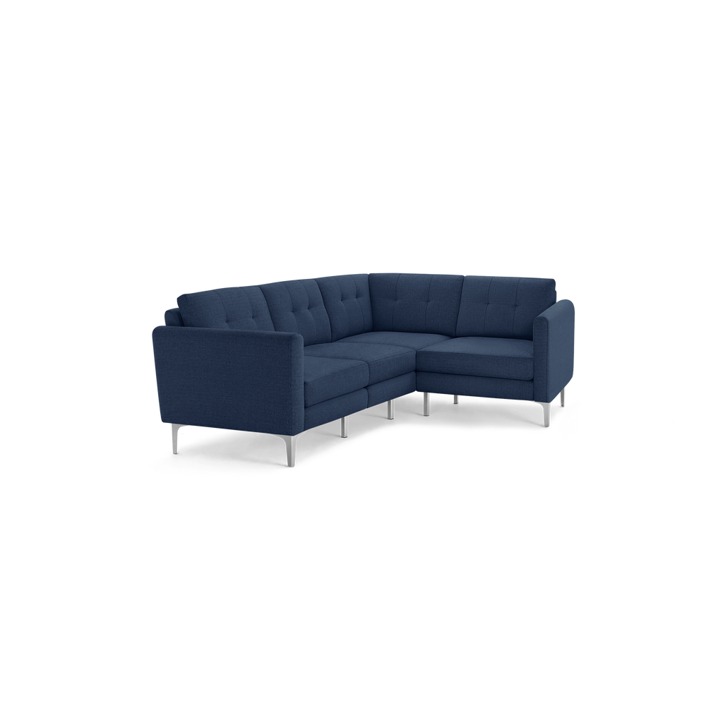Modern navy blue fabric sectional sofa with tufted back cushions and sleek silver metal legs, designed for corner seating.