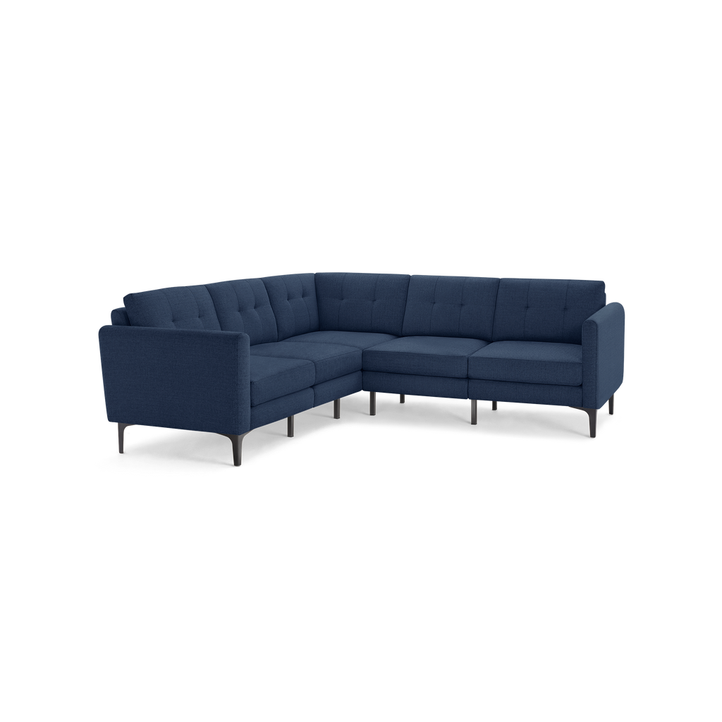 Modern L-shaped sectional sofa in navy blue fabric with tufted back cushions and slim black metal legs.