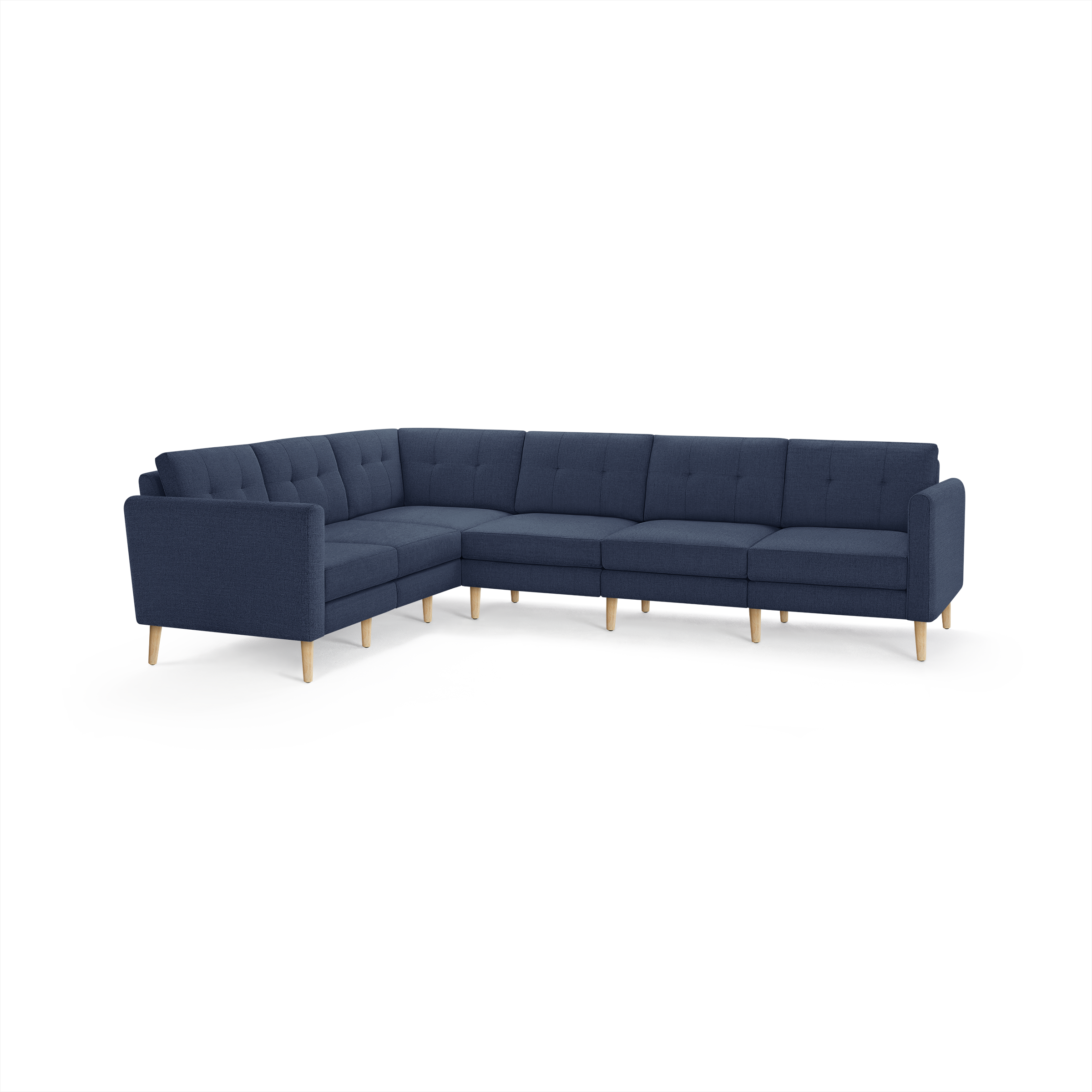 Dark blue fabric L-shaped sectional sofa with tufted back cushions and light wooden legs on white background.