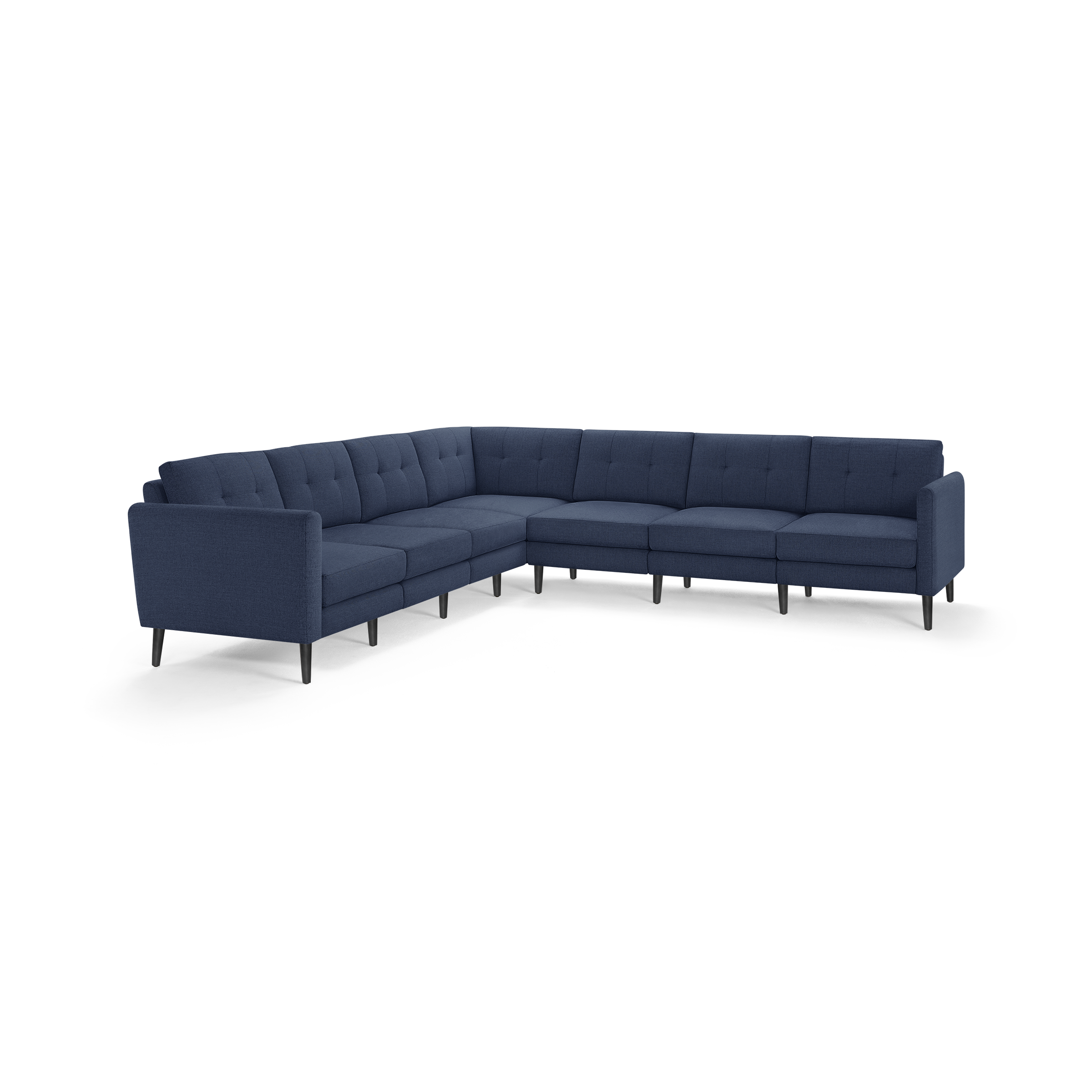 Large L-shaped sectional sofa with navy-blue fabric upholstery, tufted cushions, and slender black legs.