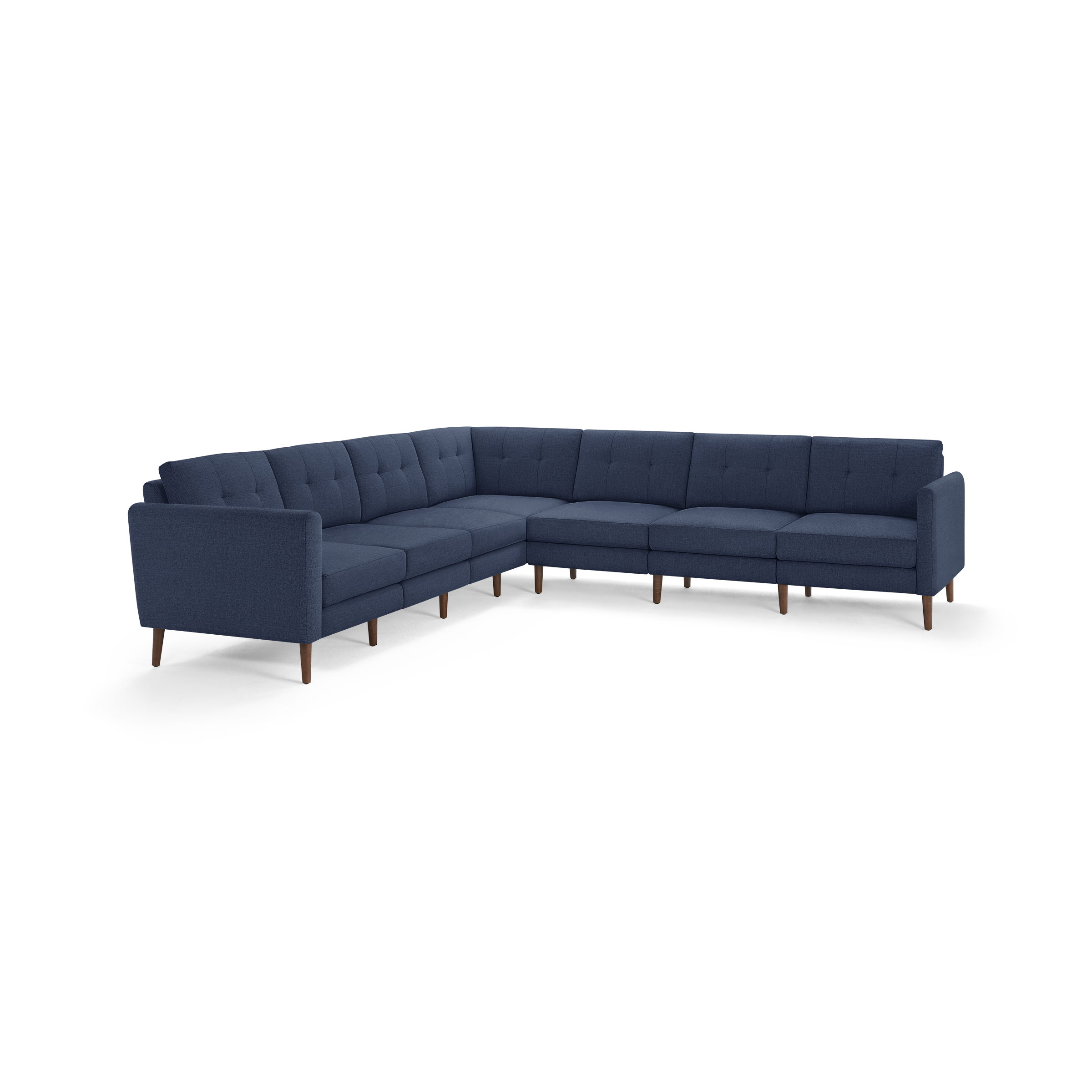 Large modern L-shaped sectional sofa with deep blue tufted fabric upholstery and wooden legs.