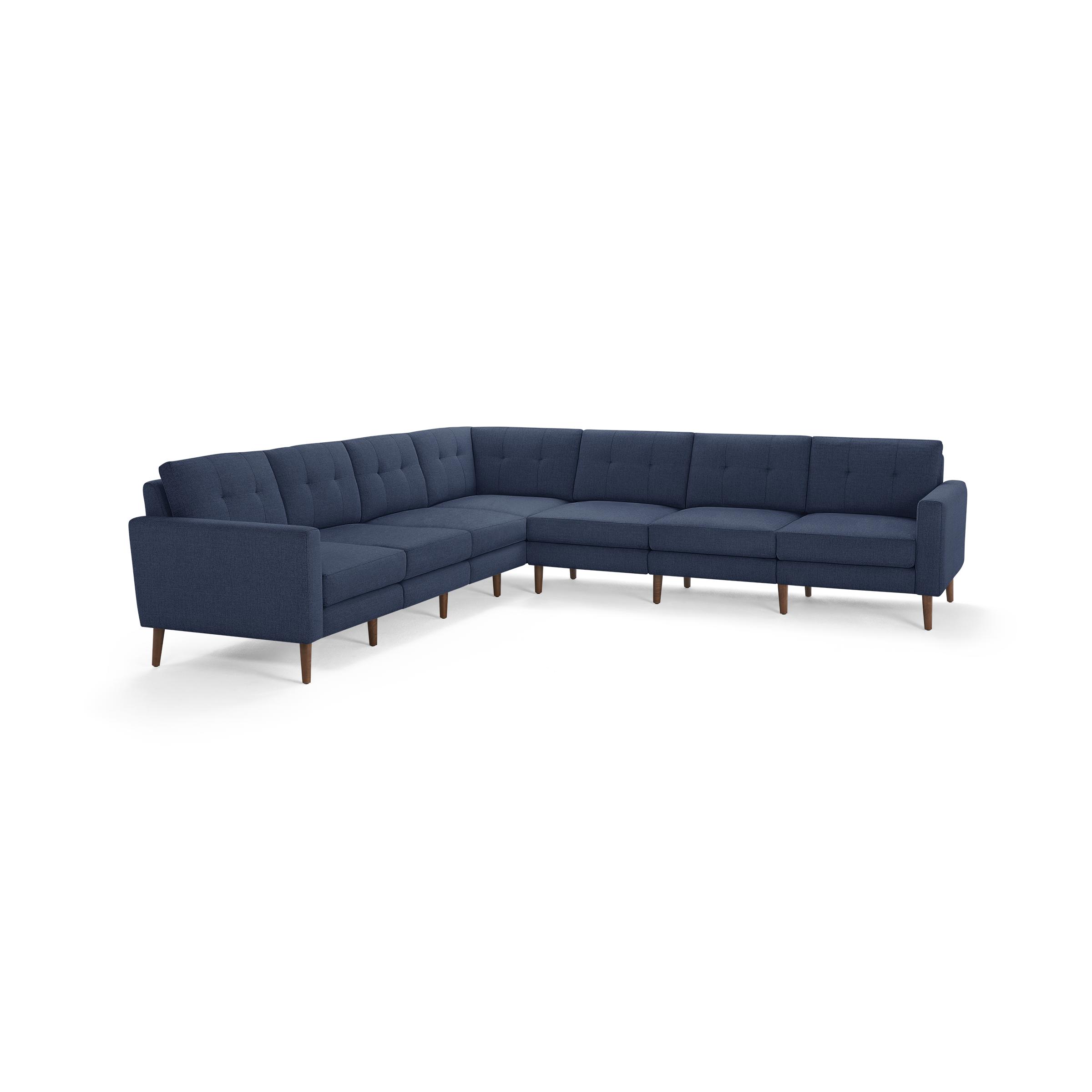 Large L-shaped sectional sofa with deep blue fabric upholstery, tufted back cushions, and wooden tapered legs.