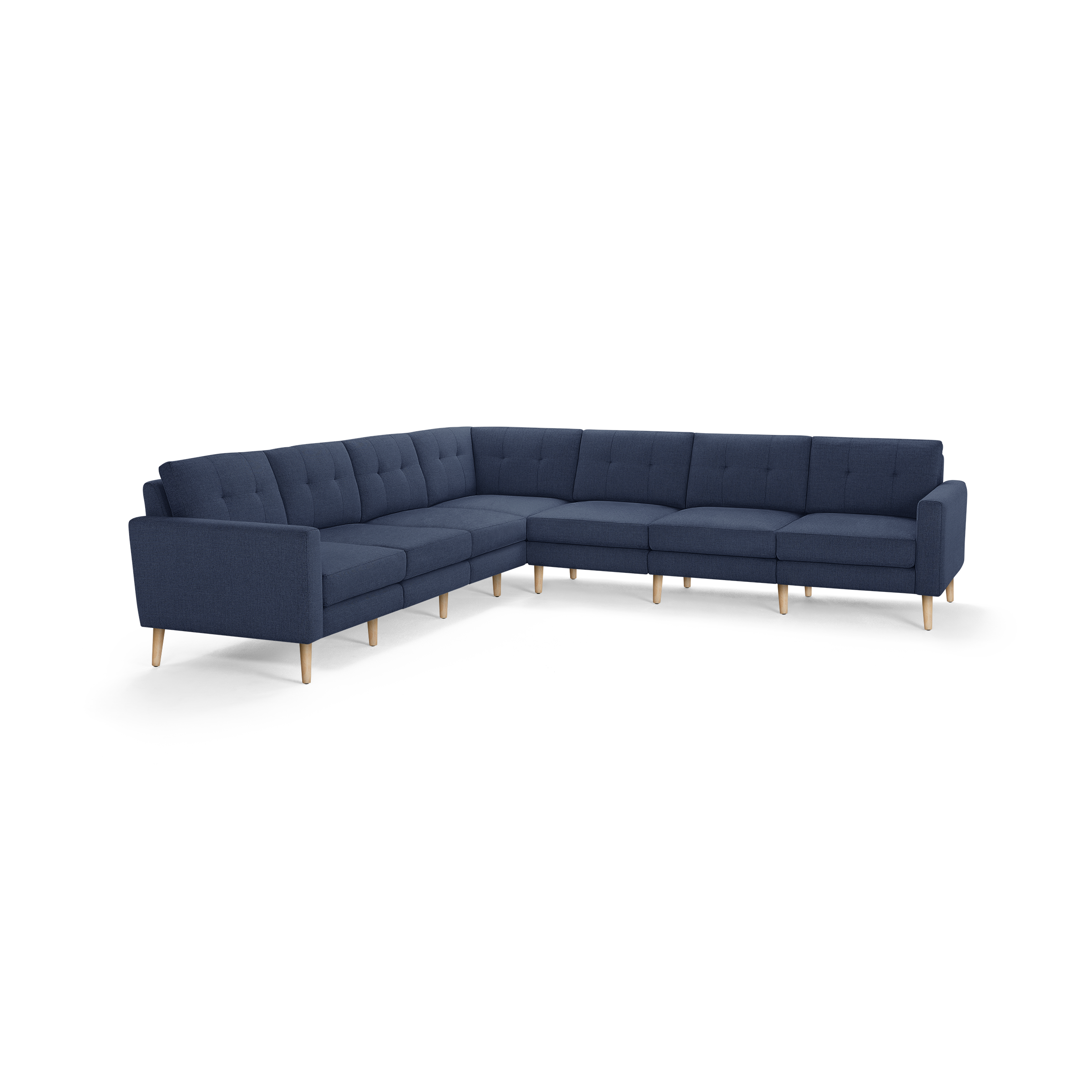 Large L-shaped sectional sofa with navy blue tufted upholstery and light wooden legs, featuring cushioned seats and backs.