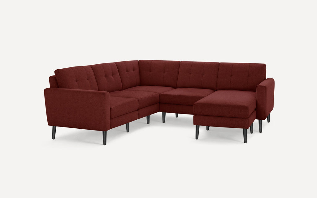 Modern sectional sofa with deep red fabric upholstery, button-tufted back cushions, and black tapered legs on white background.