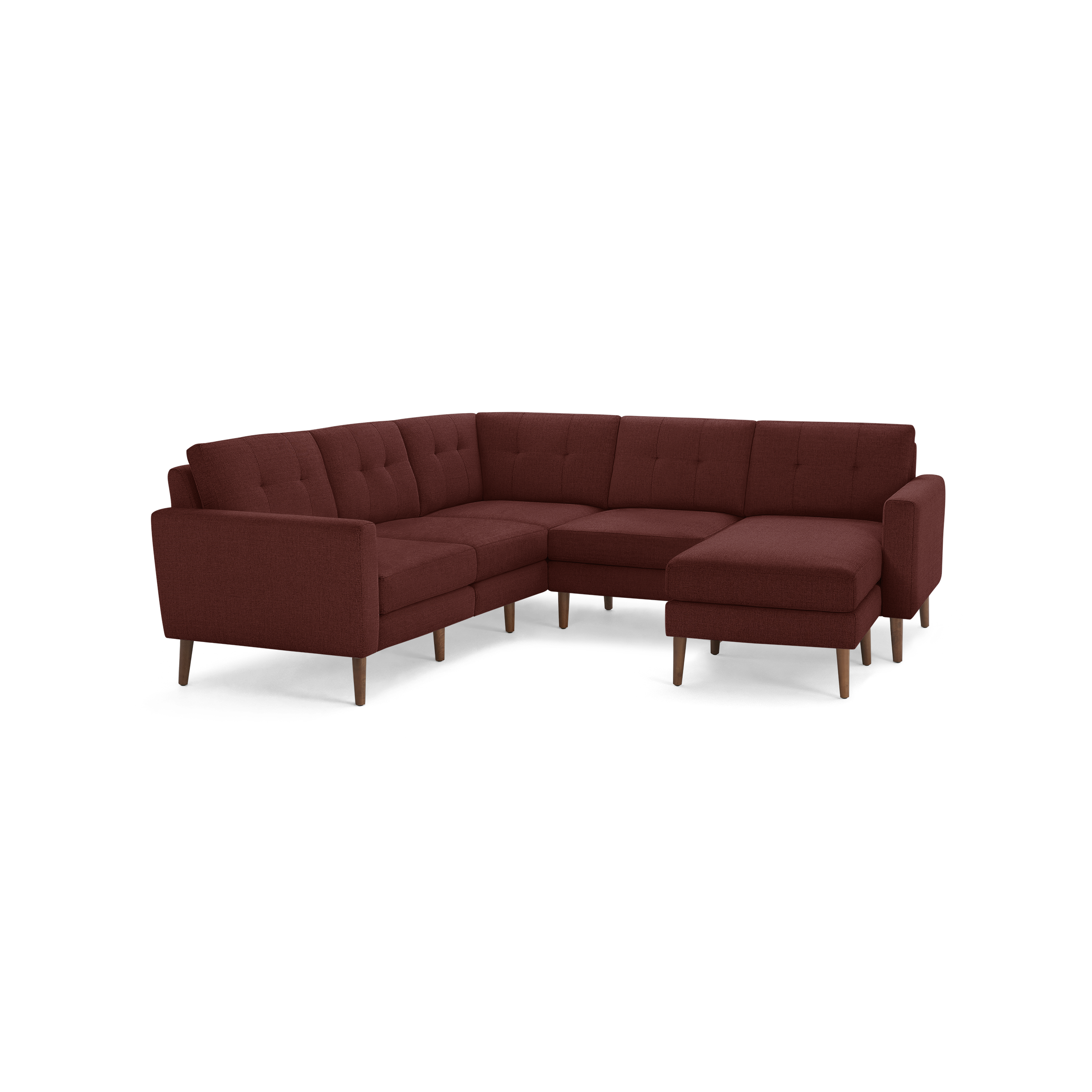 Modern L-shaped sectional sofa in deep red fabric with tufted back cushions and wooden legs, featuring a chaise lounge on the right side.