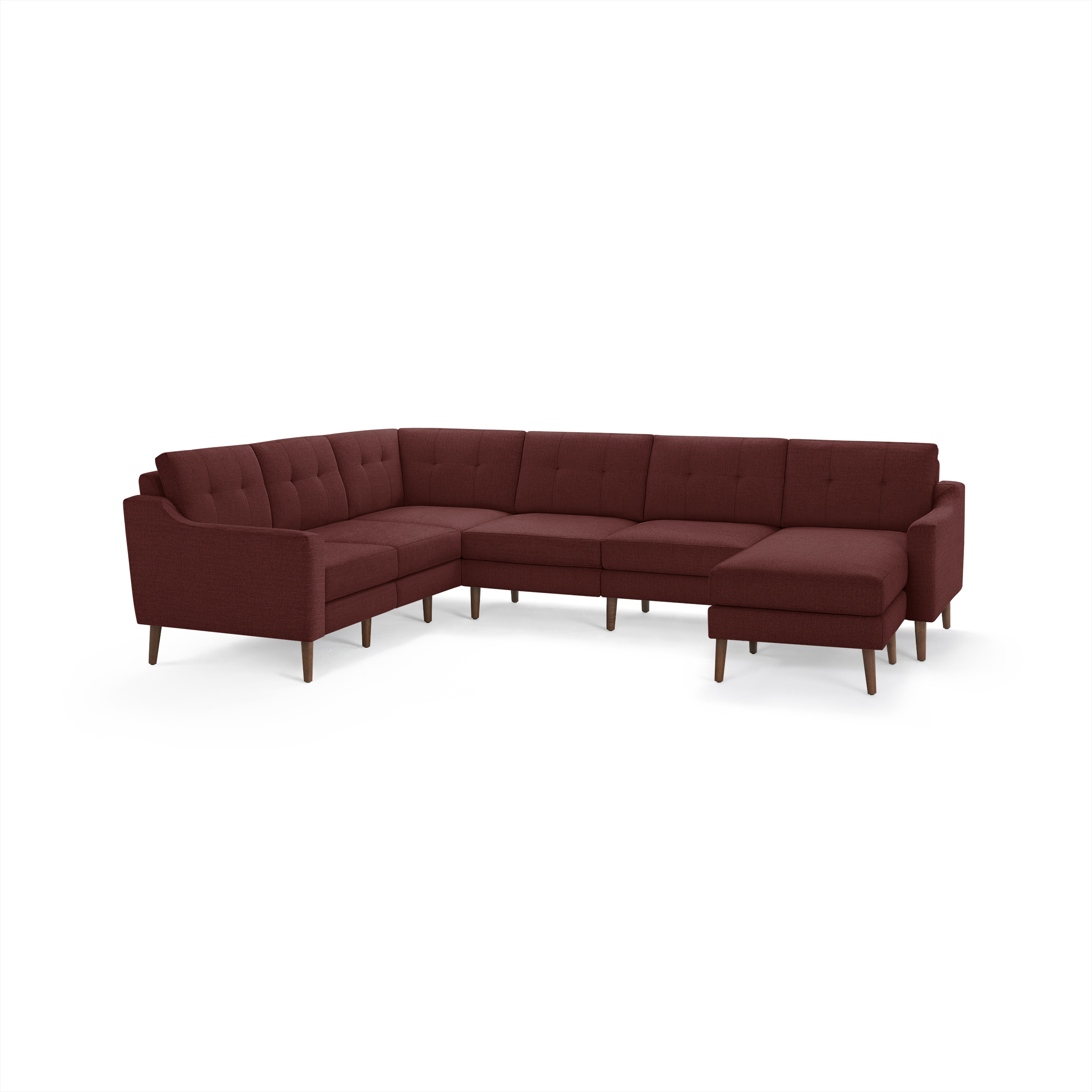 Modern L-shaped sectional sofa in deep red fabric with tufted back cushions and wooden legs, designed for spacious living rooms.