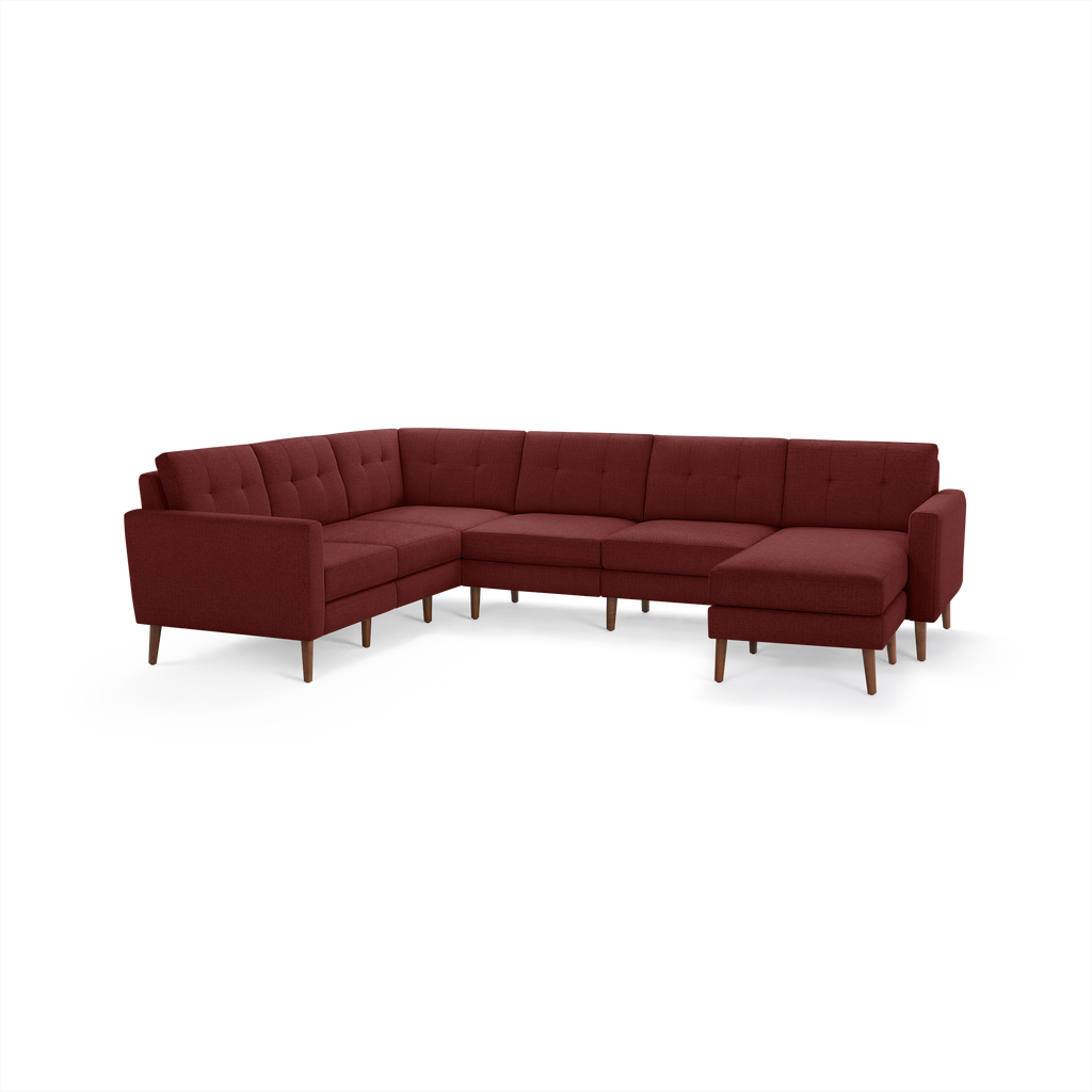 Modern L-shaped sectional sofa in deep red fabric with tufted back cushions and wooden legs.
