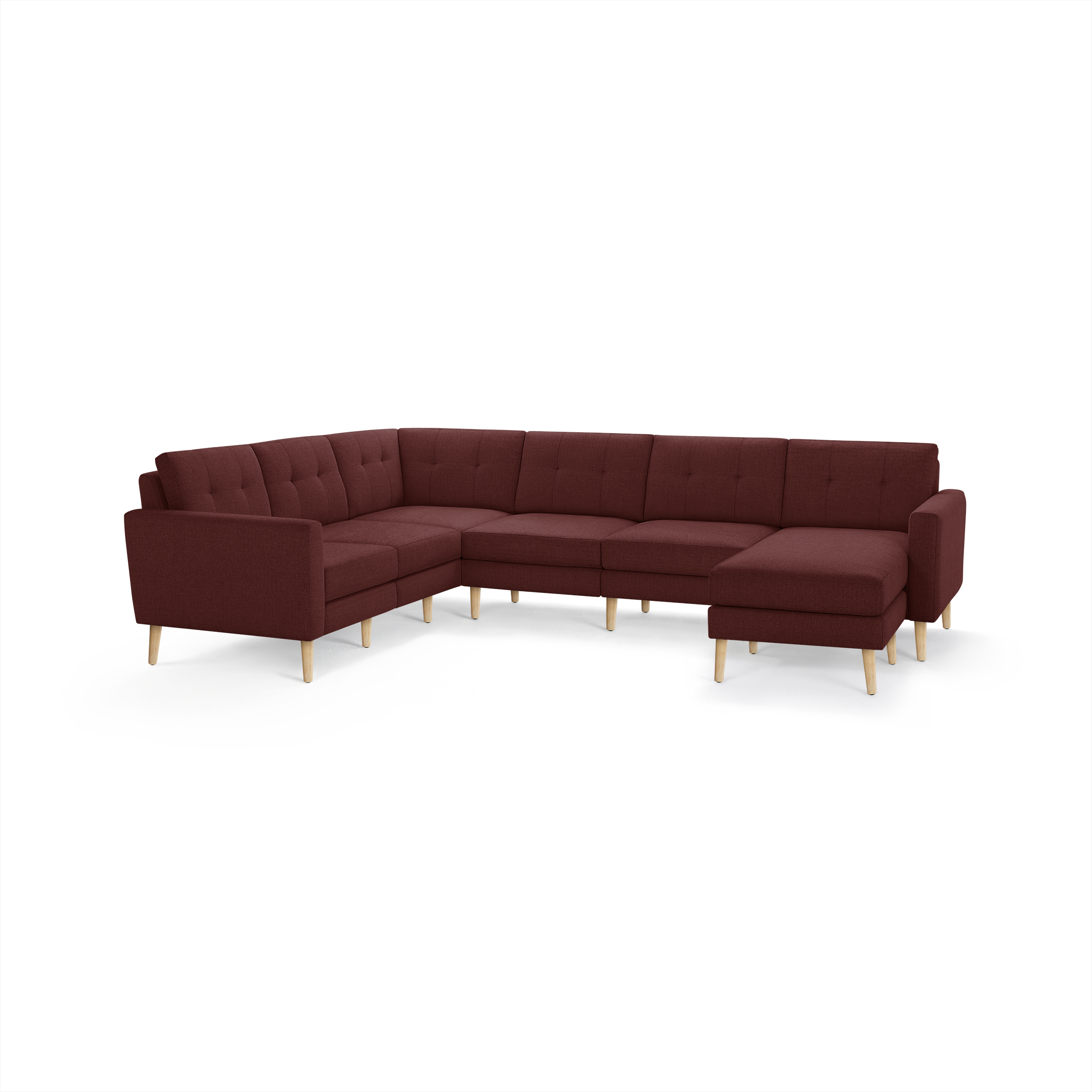 Large L-shaped sectional sofa with deep red fabric upholstery, tufted back cushions, and light wood tapered legs.