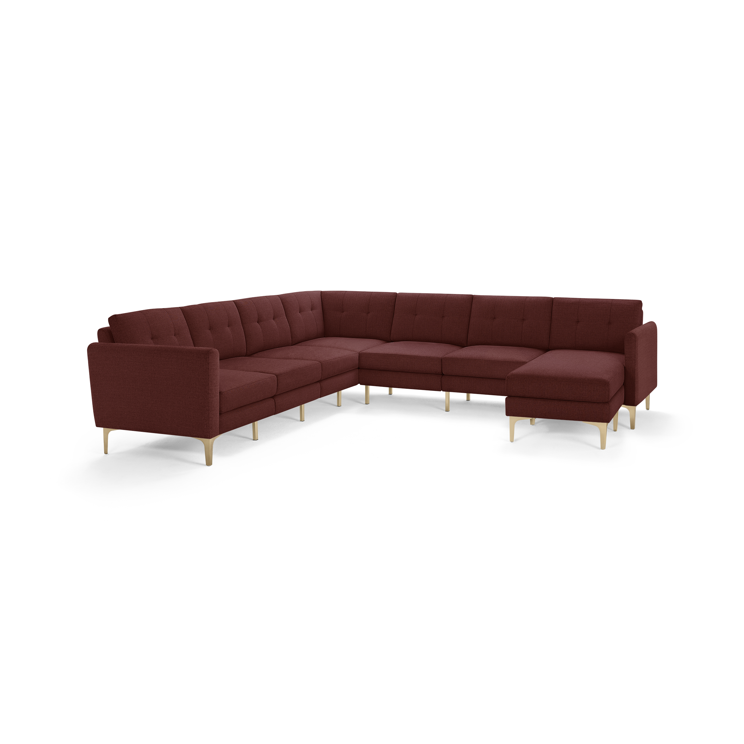 Large L-shaped sectional sofa with deep burgundy upholstery, tufted back cushions, slim armrests, and light wooden legs.