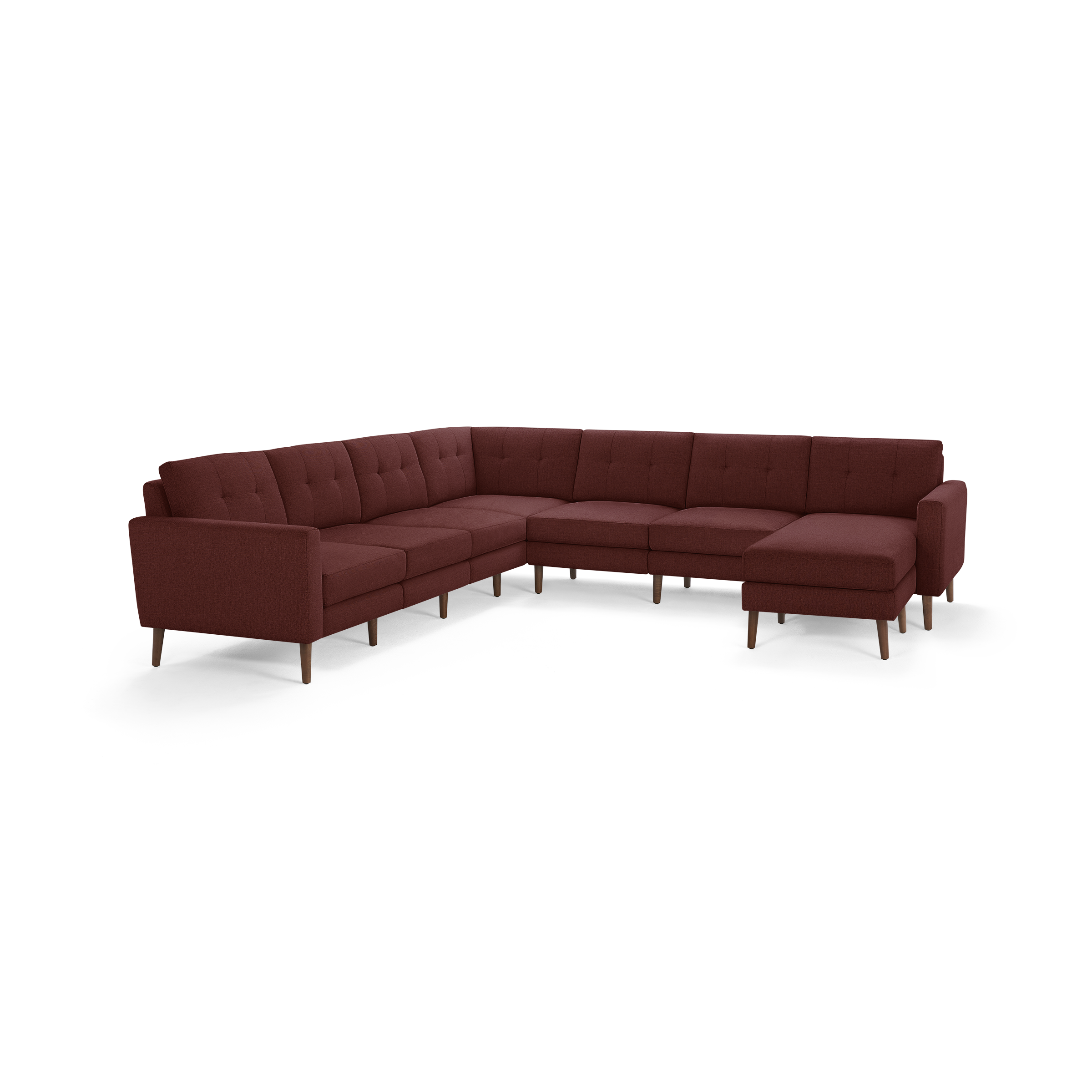 Large L-shaped sectional sofa in deep red fabric with tufted back cushions and wooden legs.