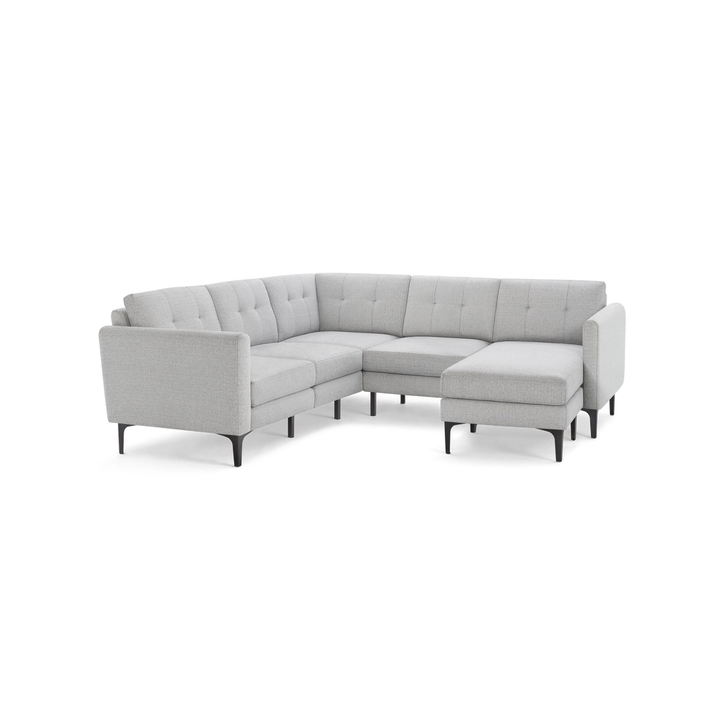 Light gray L-shaped sectional sofa with tufted cushions, slim armrests, and black tapered legs, modern design.
