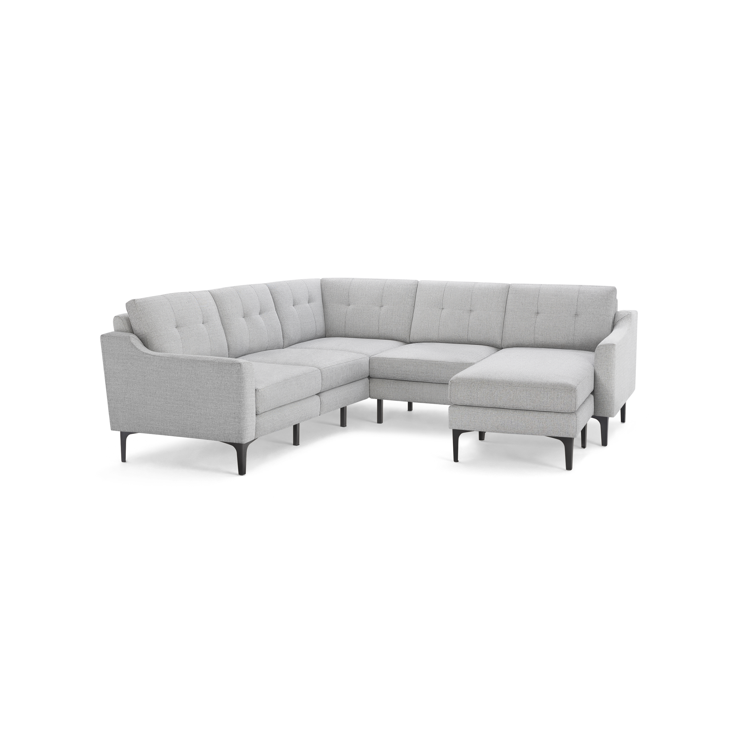 Light gray upholstered L-shaped sectional sofa with tufted back cushions and slim black legs.