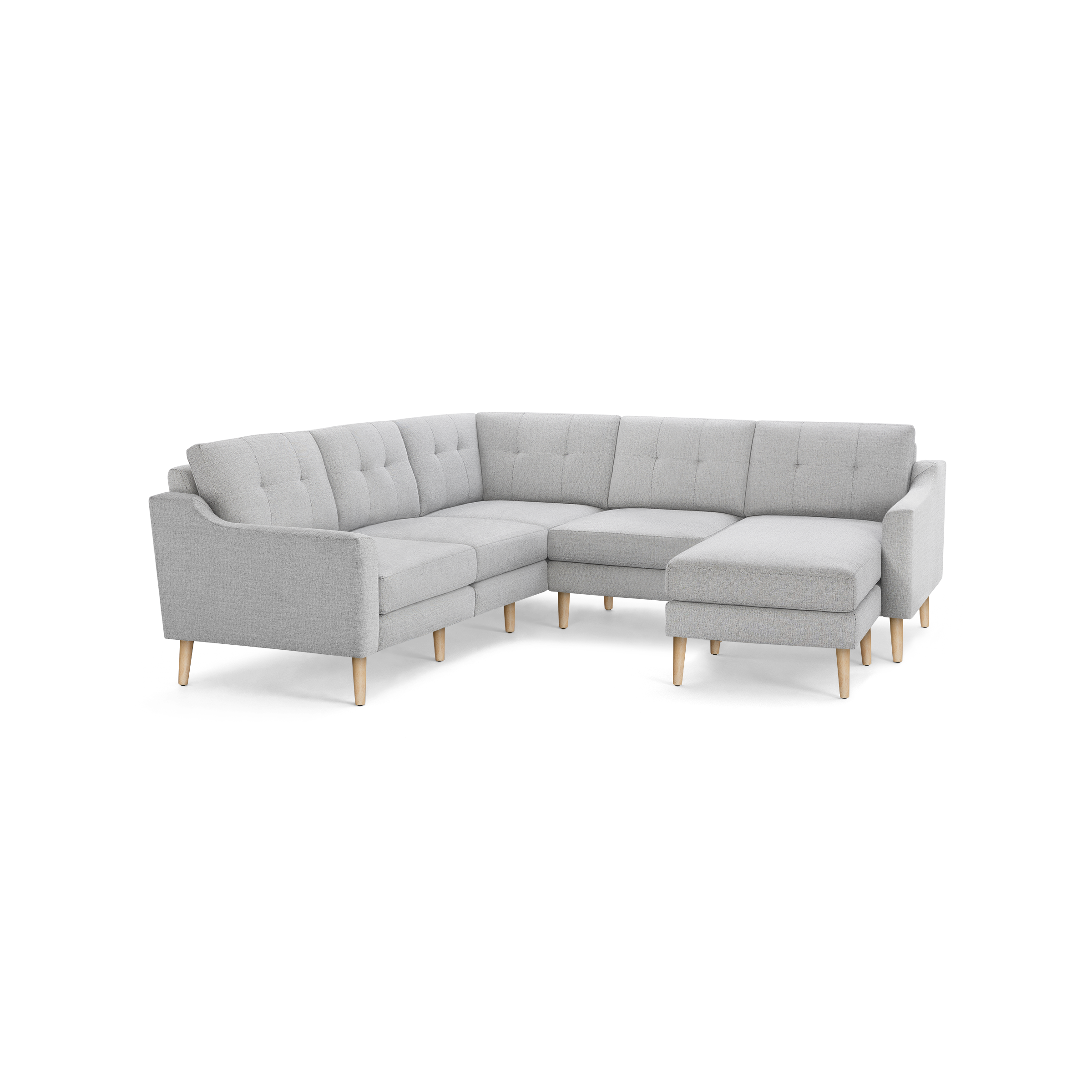 Light gray fabric L-shaped sectional sofa with tufted back cushions and wooden legs, featuring a chaise lounge on the right side.