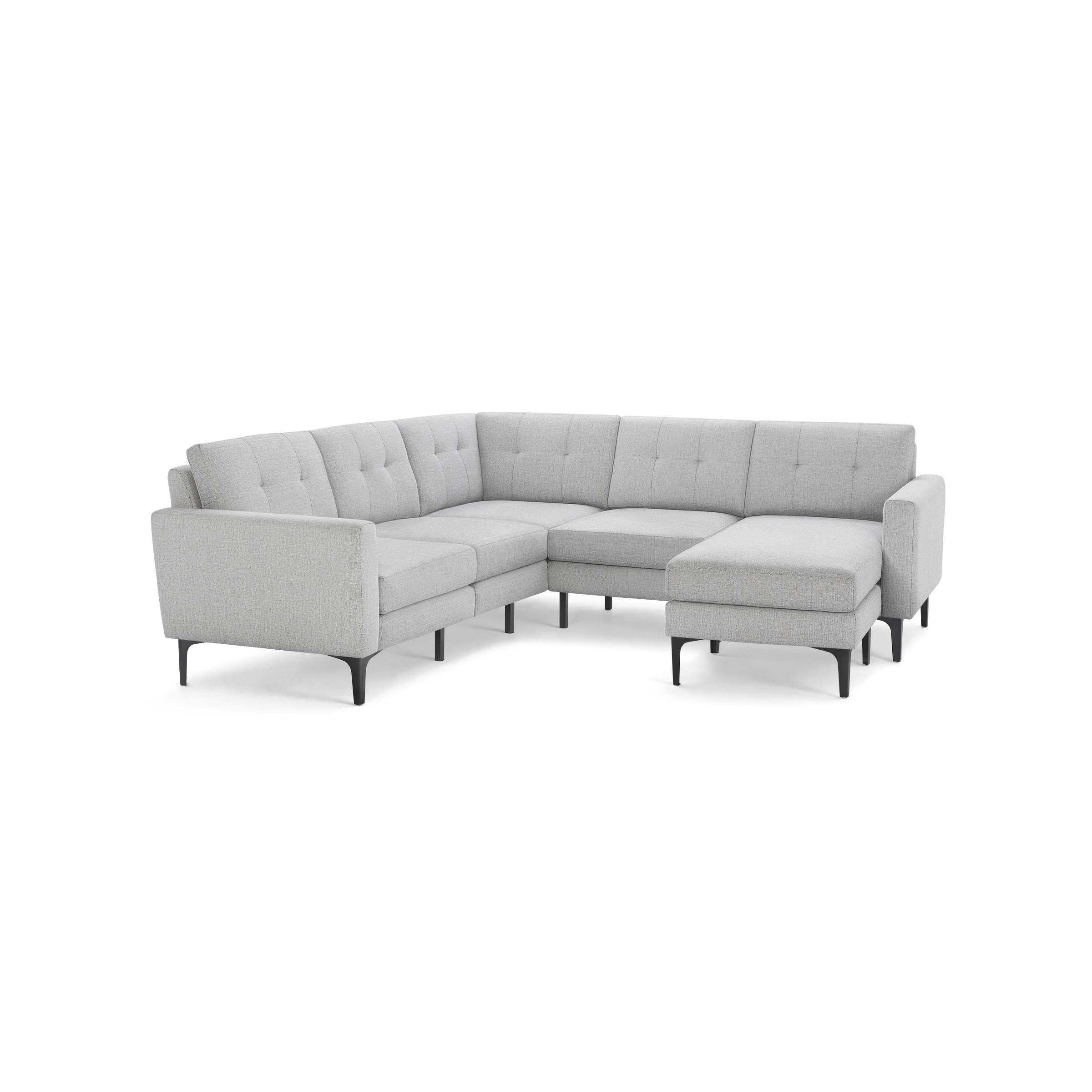 Light gray modern L-shaped sectional sofa with tufted cushions, slim black legs, and a chaise lounge on the right side.