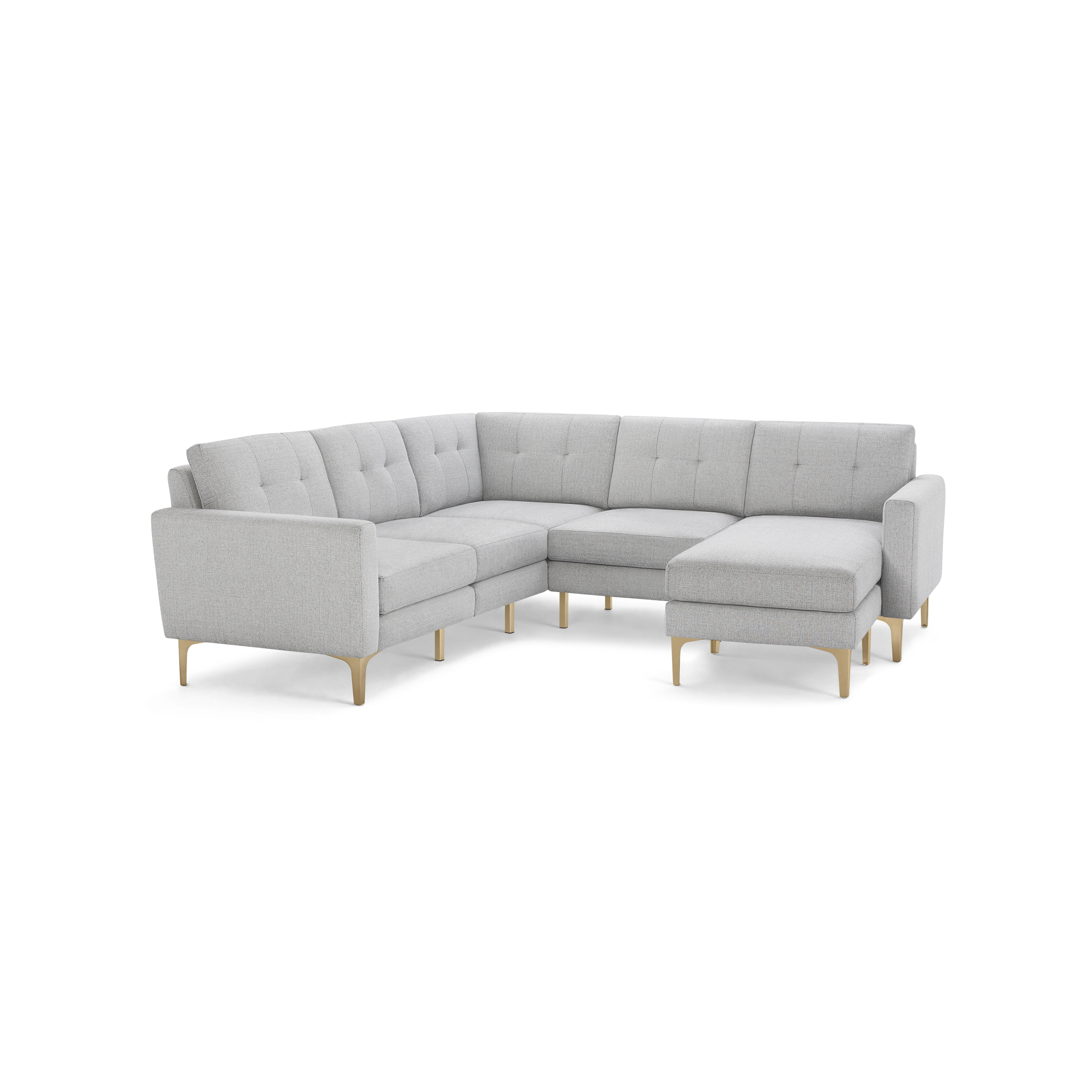 Light gray L-shaped sectional sofa with tufted back cushions and light wooden legs, featuring a chaise lounge on the right side.
