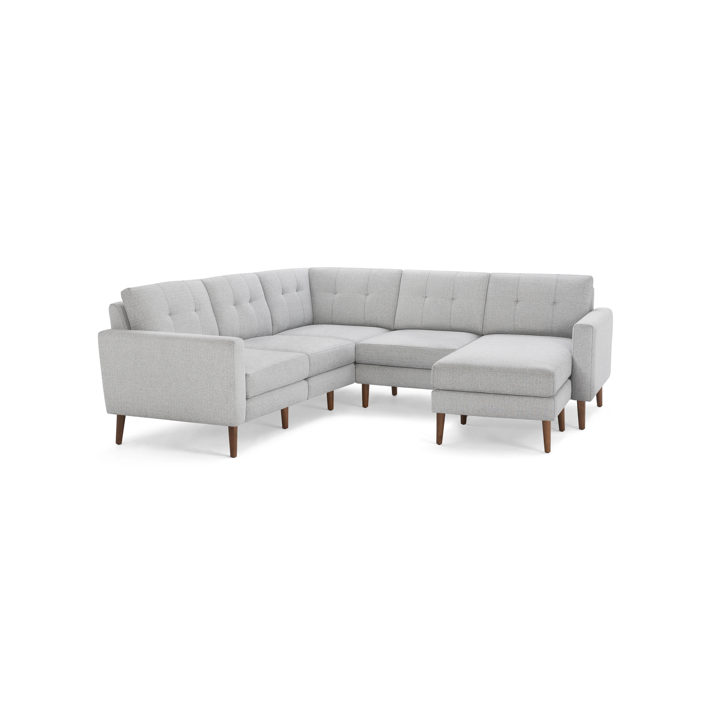 Light gray upholstered L-shaped sectional sofa with tufted back cushions and wooden tapered legs.