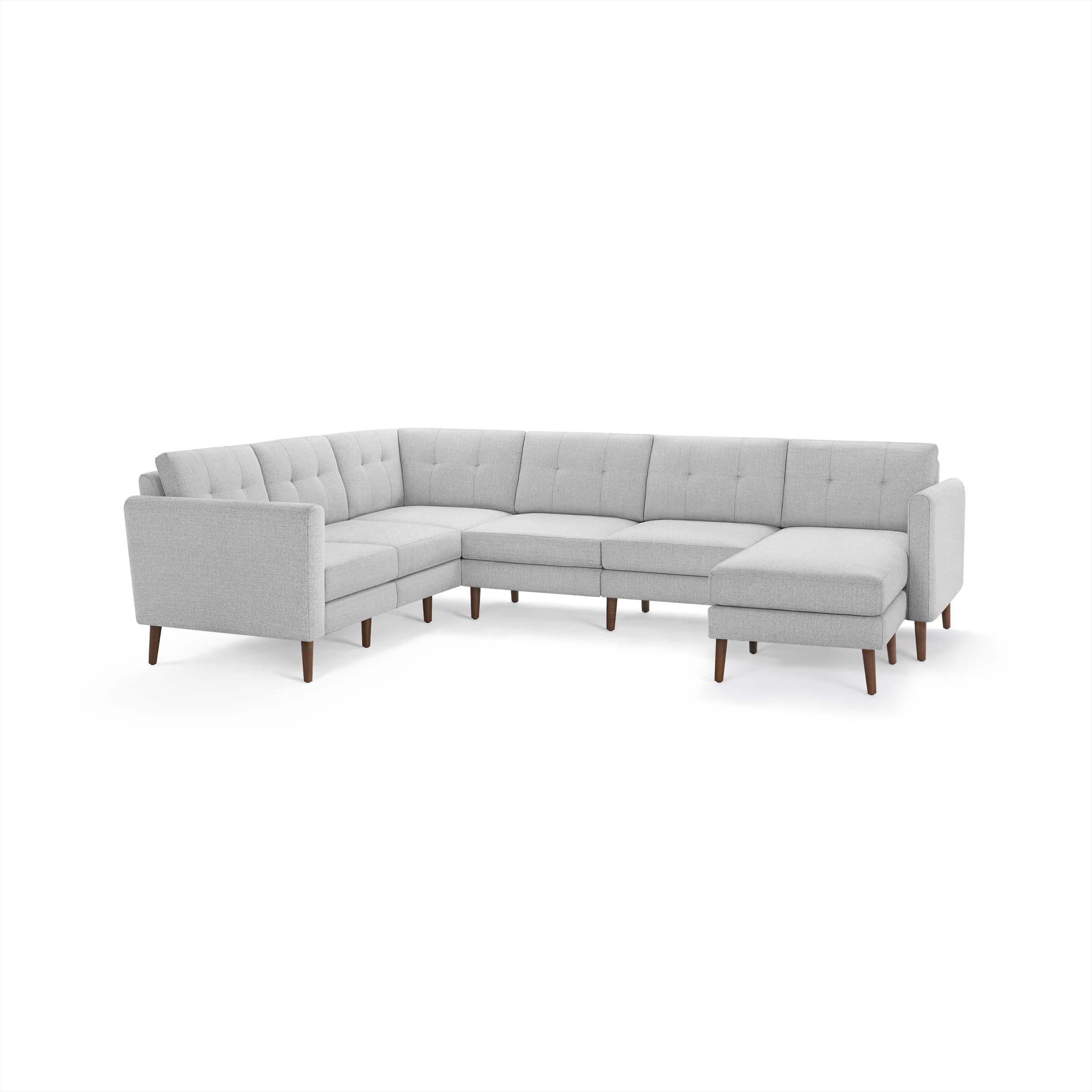 Light gray fabric sectional sofa with tufted back cushions, wooden legs, and chaise lounge on right side.