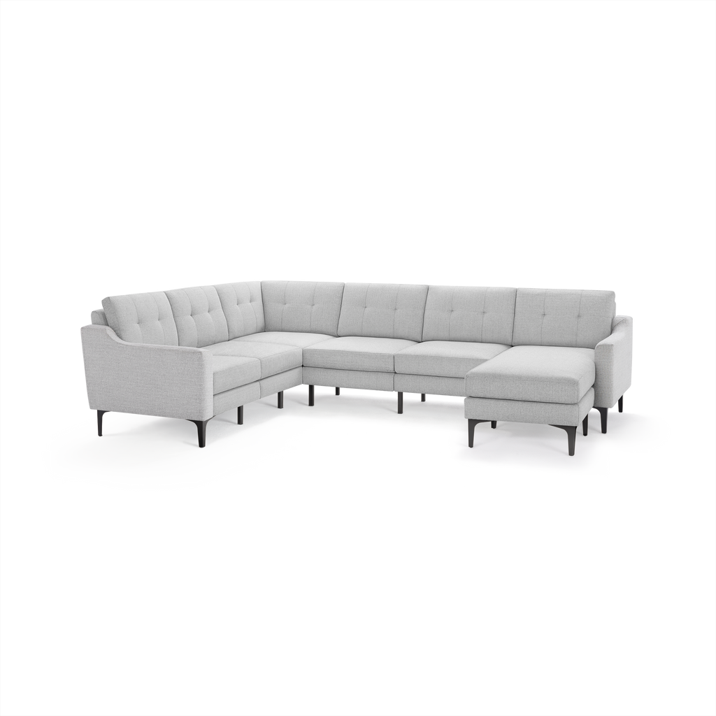 Light gray, modern L-shaped sectional sofa with tufted back cushions and slim black angled legs.