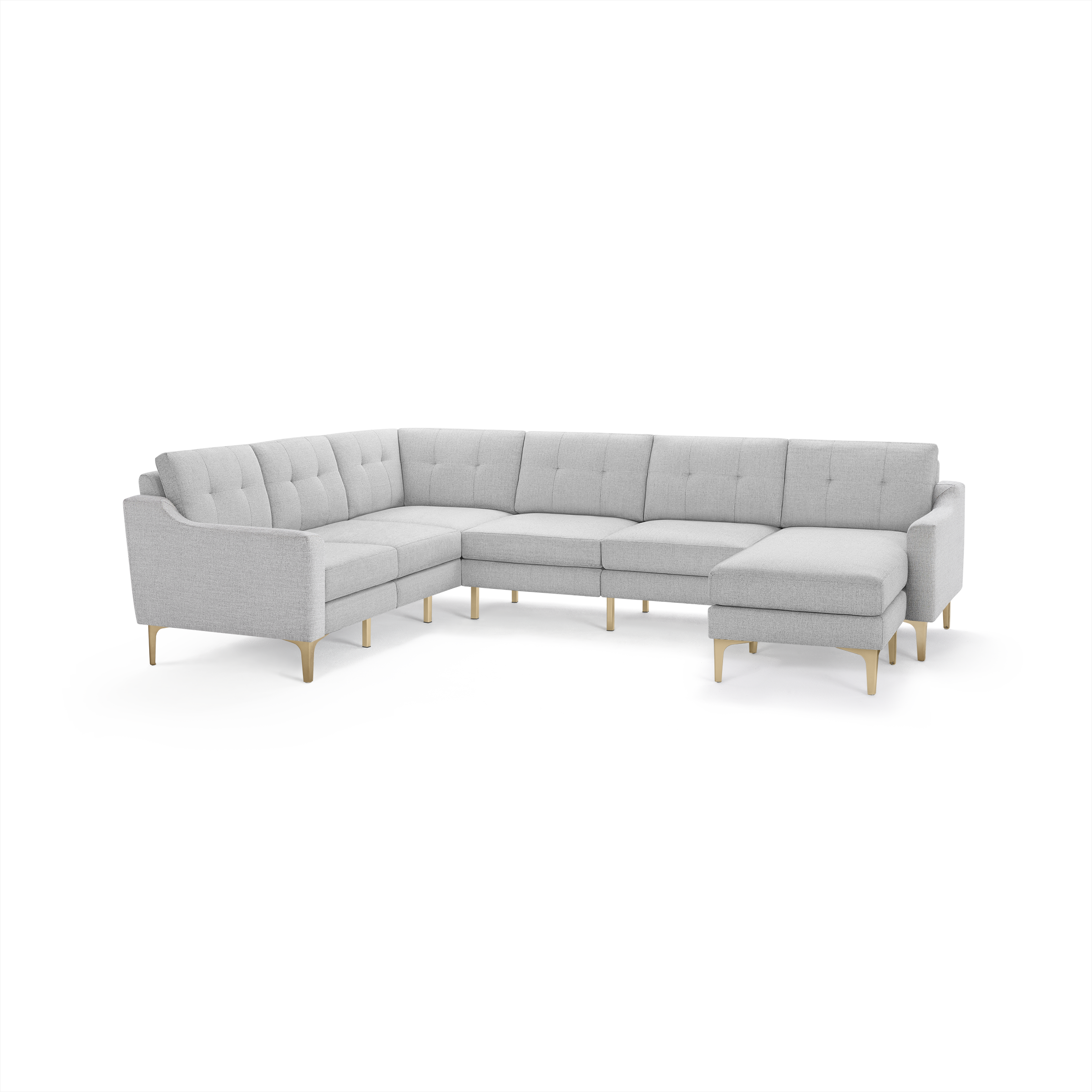 Light gray fabric sectional sofa with L-shape design, tufted back cushions, slim wooden legs, and a chaise lounge on the right side.