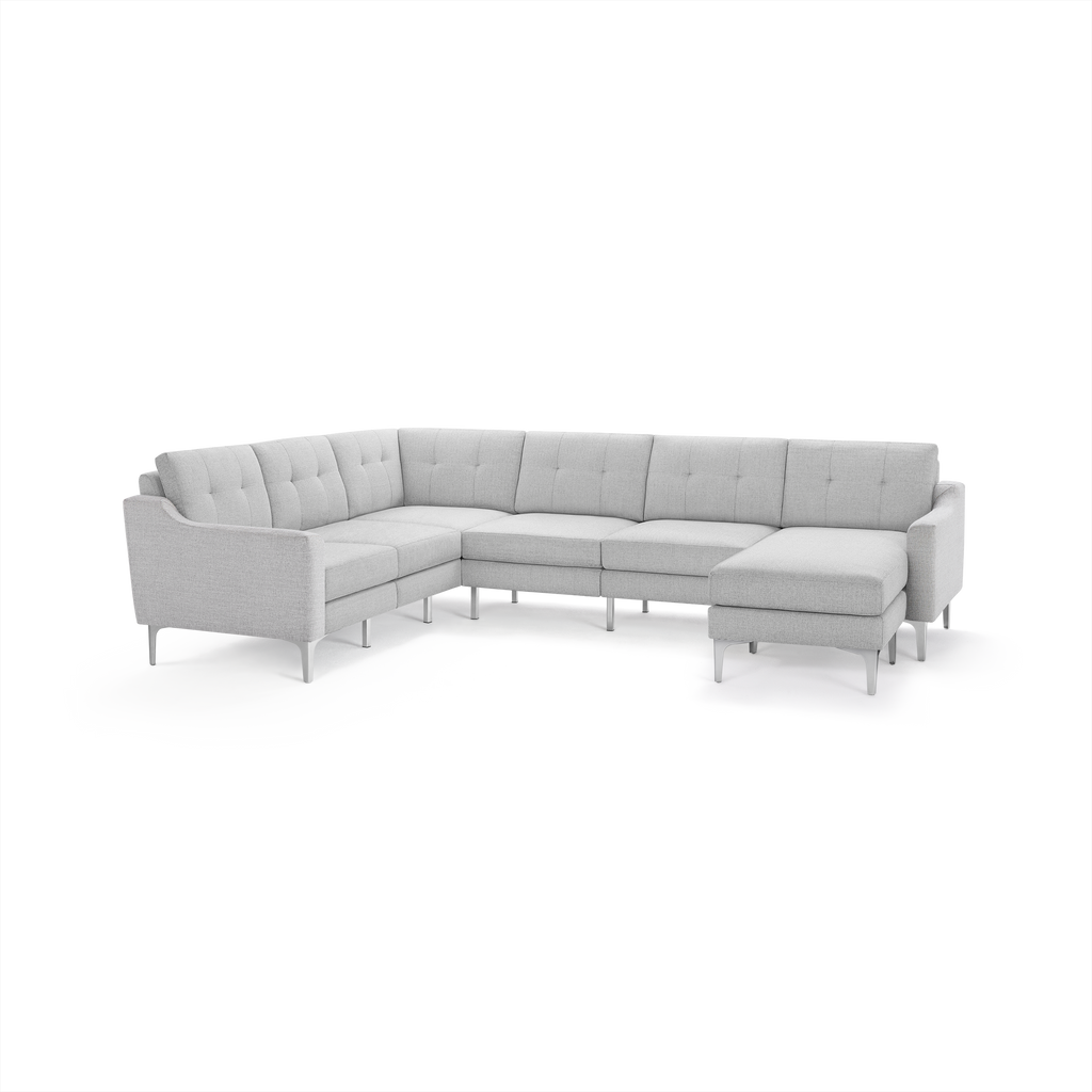 Light gray L-shaped sectional sofa with modern metal legs, tufted back cushions, and right chaise lounge.
