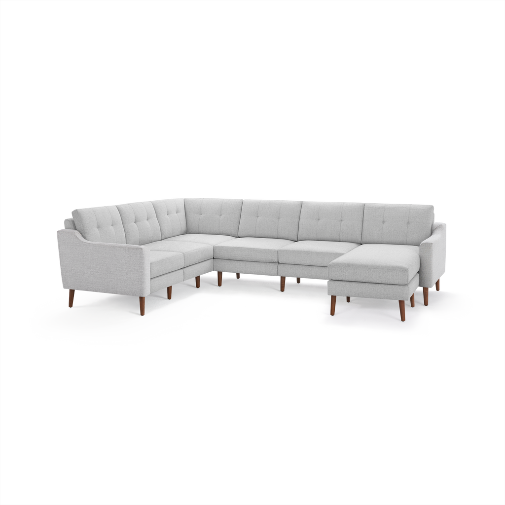 Light gray modern L-shaped sectional sofa with button-tufted back cushions and wooden legs.