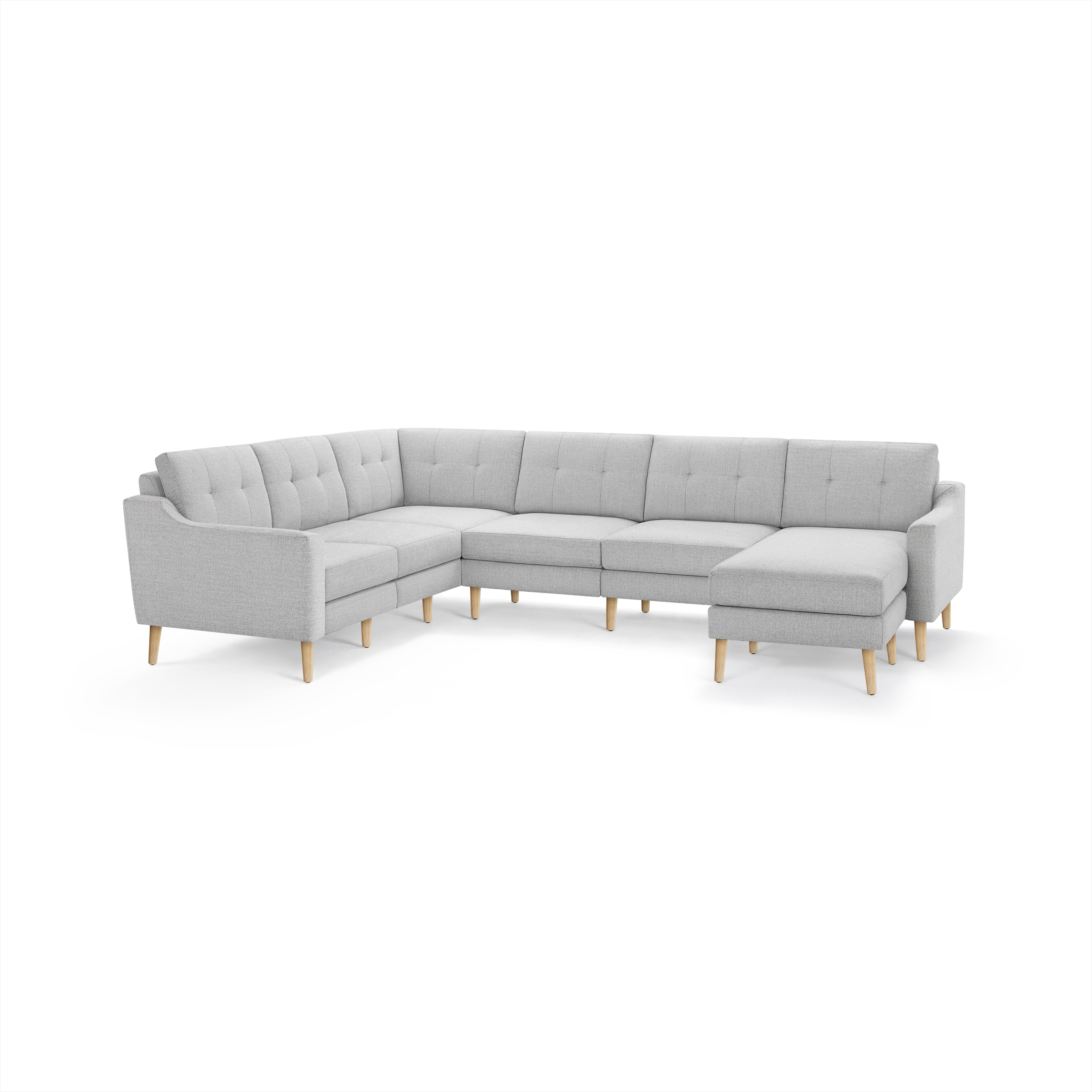 Light gray L-shaped sectional sofa with tufted cushions and wooden legs, featuring a chaise lounge on the right side.