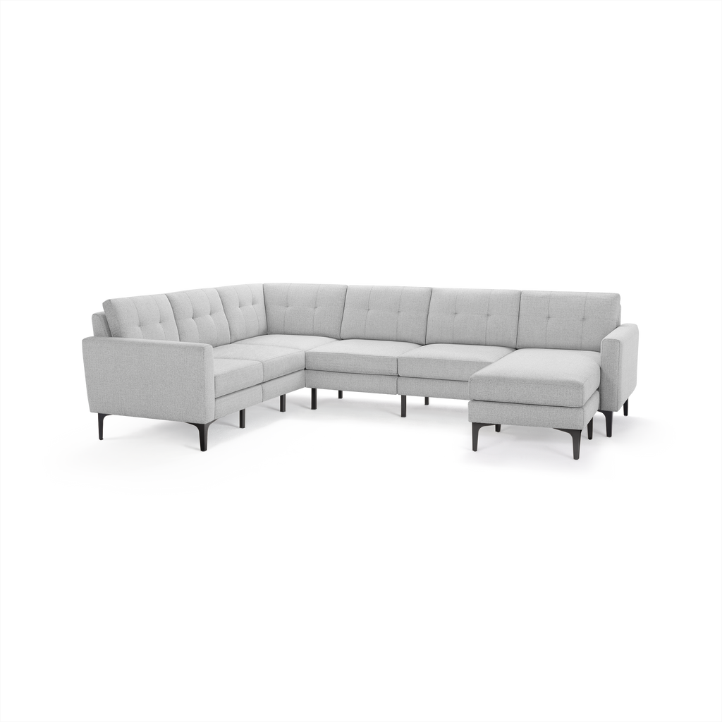 Light gray fabric L-shaped sectional sofa with tufted back cushions and black tapered legs.
