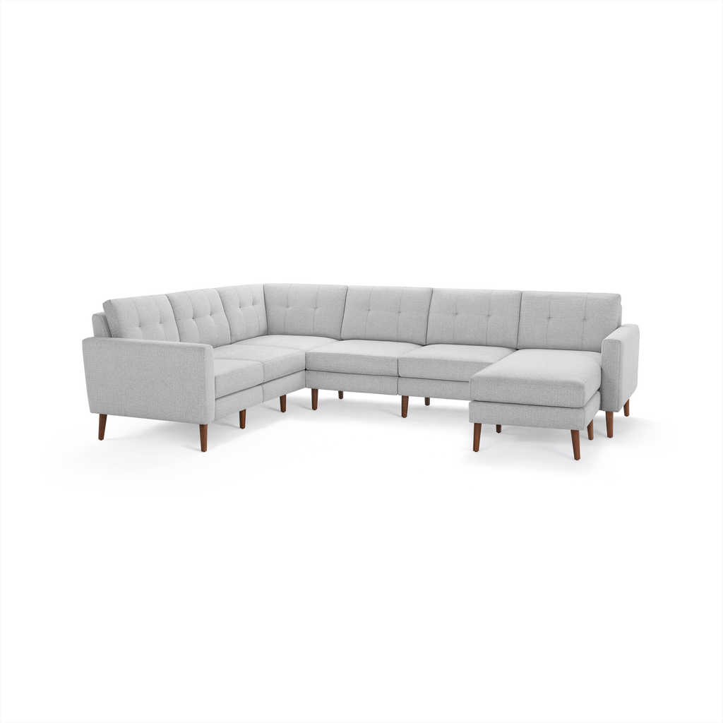 Light gray fabric sectional sofa with tufted cushions, wooden legs, and a right-side chaise lounge.