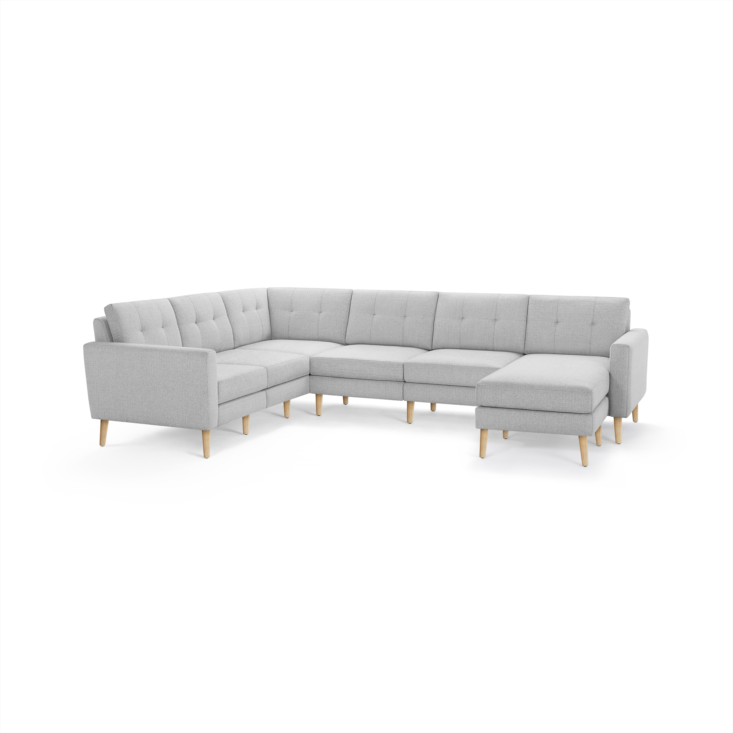 Light gray fabric L-shaped sectional sofa with tufted back cushions and natural wooden legs.